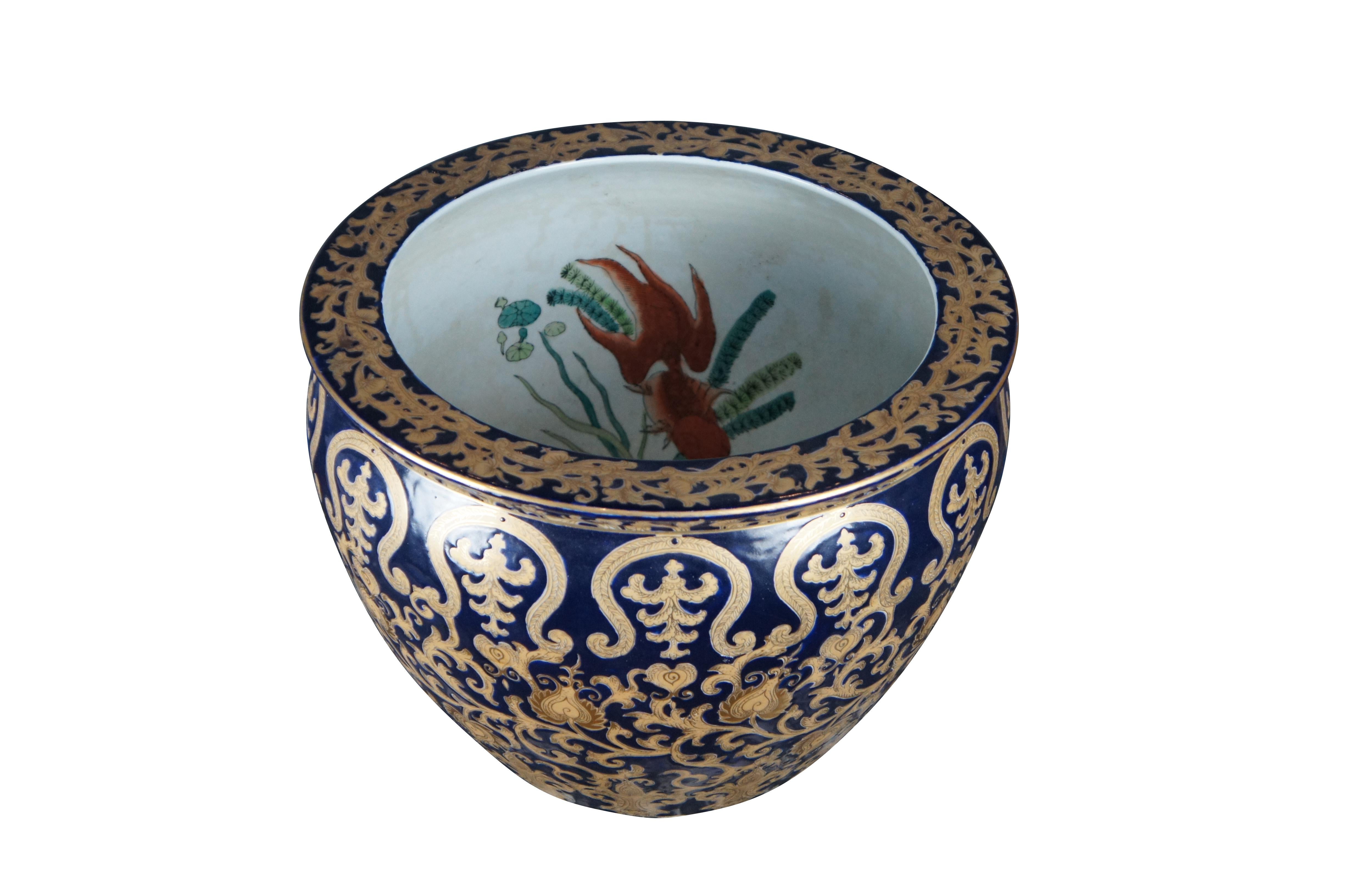 Large 20th Century Chinese porcelain fishbowl Cache Pot in navy with 24-karet gold scrolling foliate pattern. Interior is white with koi fish pattern. Stamped along underside.

Dimensions:
15