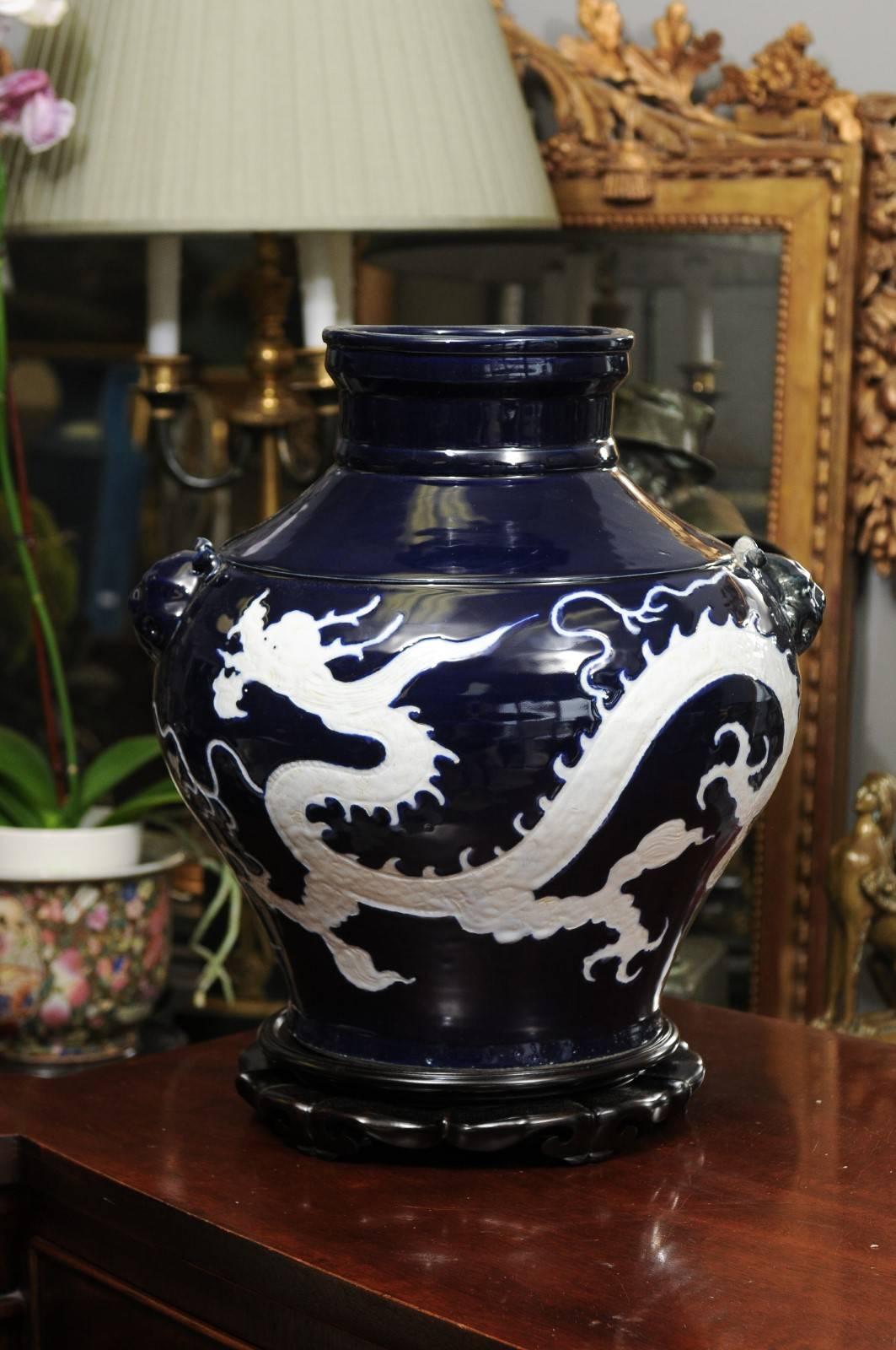 This deep blue porcelain vase is decorated with a continuous white dragon. The glaze is stunning. It is the exact replica of a Chinese Ming piece sold at auctions for millions.
The factory in China where it was made uses age old techniques.


 