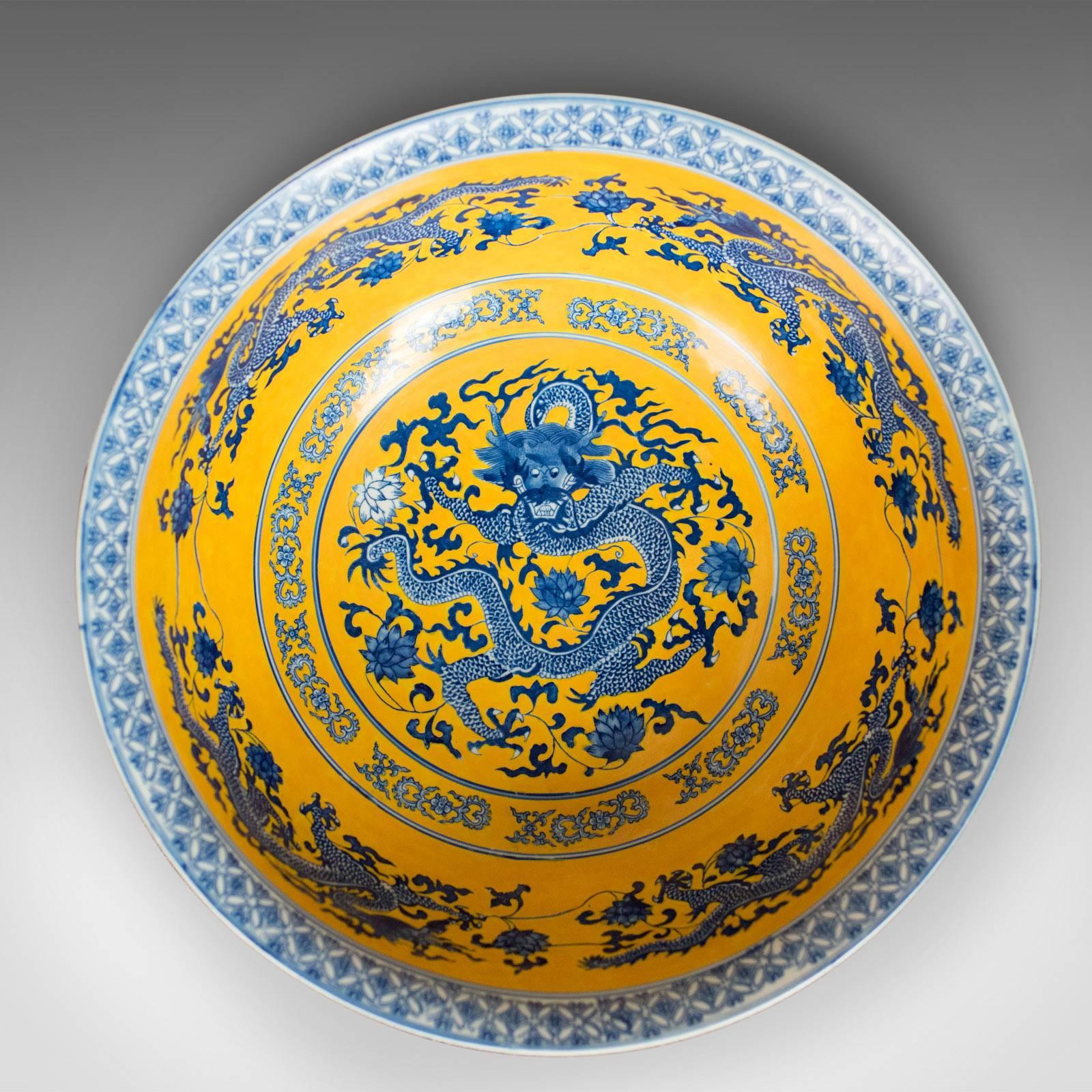 Complimentary front door shipping to the US, Canada, UK and the EU —

This is a large Chinese porcelain bowl in blue, white and yellow dating to the late 20th century.

An attractive bowl in good condition throughout
Painted with dragons over a
