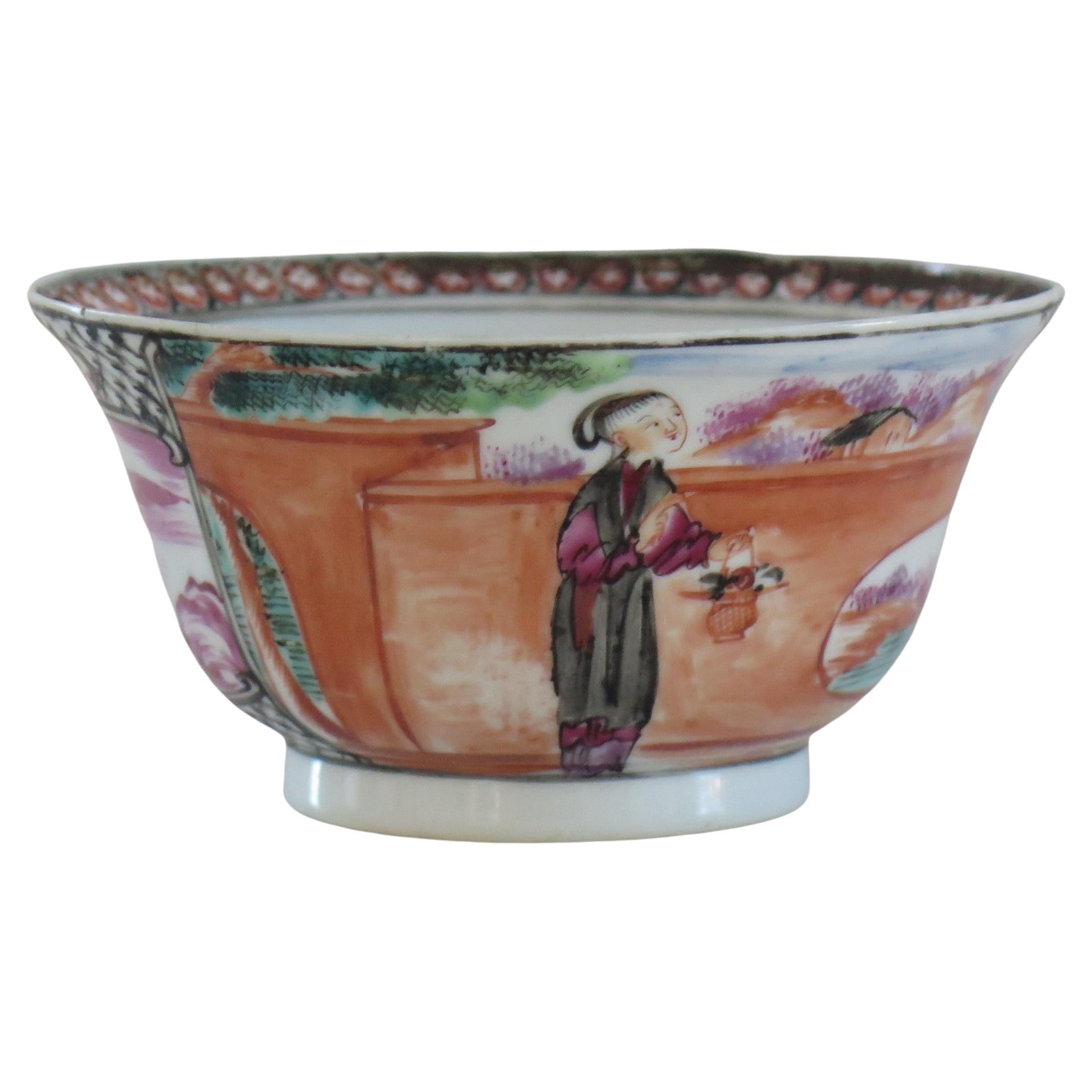 This is a finely hand painted Chinese porcelain bowl from the 18th century, Qing dynasty, Qianlong period, 1736-1795.

The bowl is beautifully decorated with two panels of figure scenes alternating with two magenta border panels. The figural