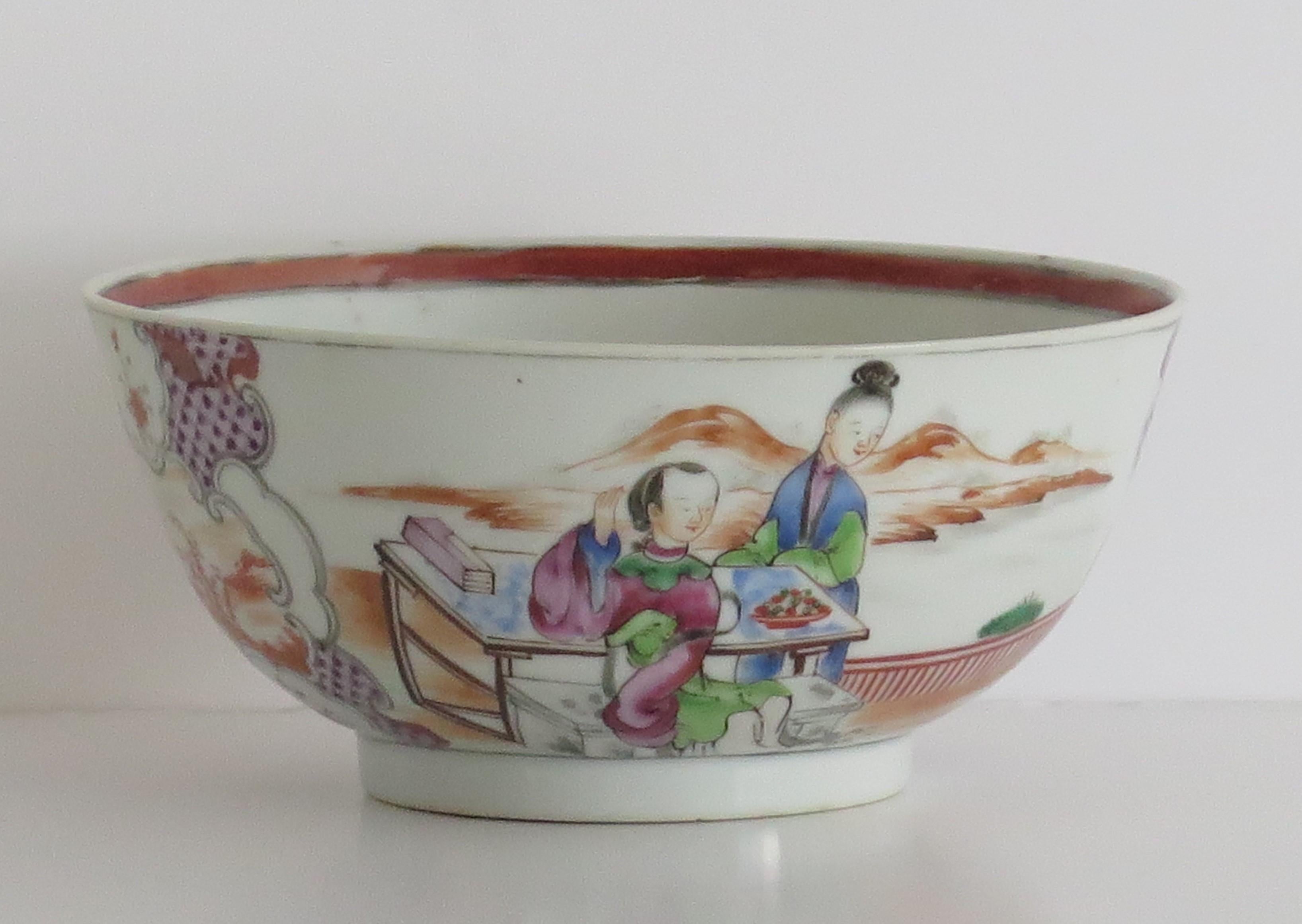 This is a finely hand painted Chinese Export porcelain bowl from the 18th century, Qing dynasty, Qianlong period, 1736-1795.

The bowl is beautifully decorated with two panels of figure scenes alternating with two magenta border panels. The