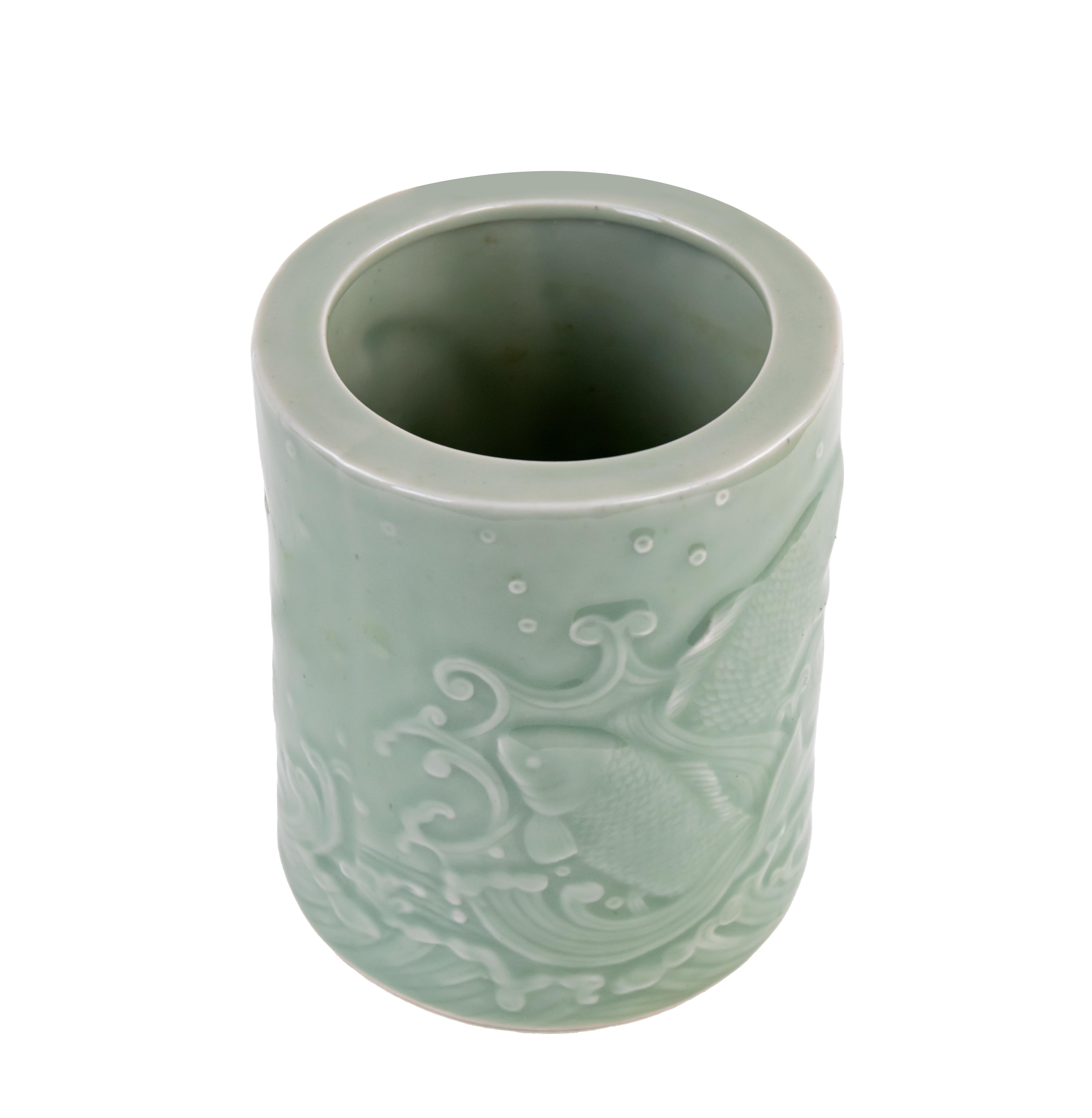 Chinese celadon enamel porcelain brush pot decorated with vegetal engravings.