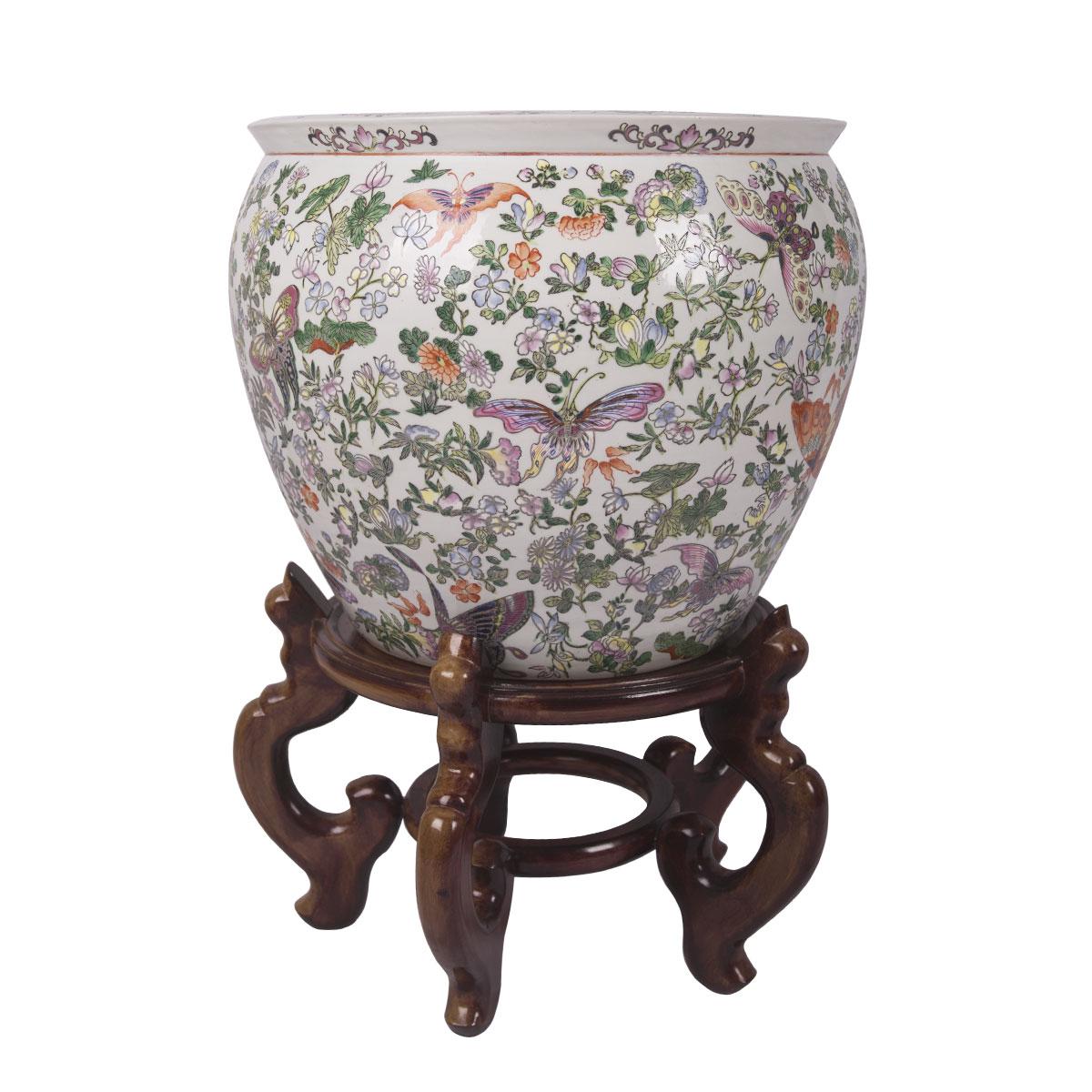These colorful matching fishbowls were created in Hong Kong, China around 1960. Both fish bowls are round in shape, these porcelain bowls features beautiful hand painted butterflies and flowers throughout the exterior of these large fish bowls. The