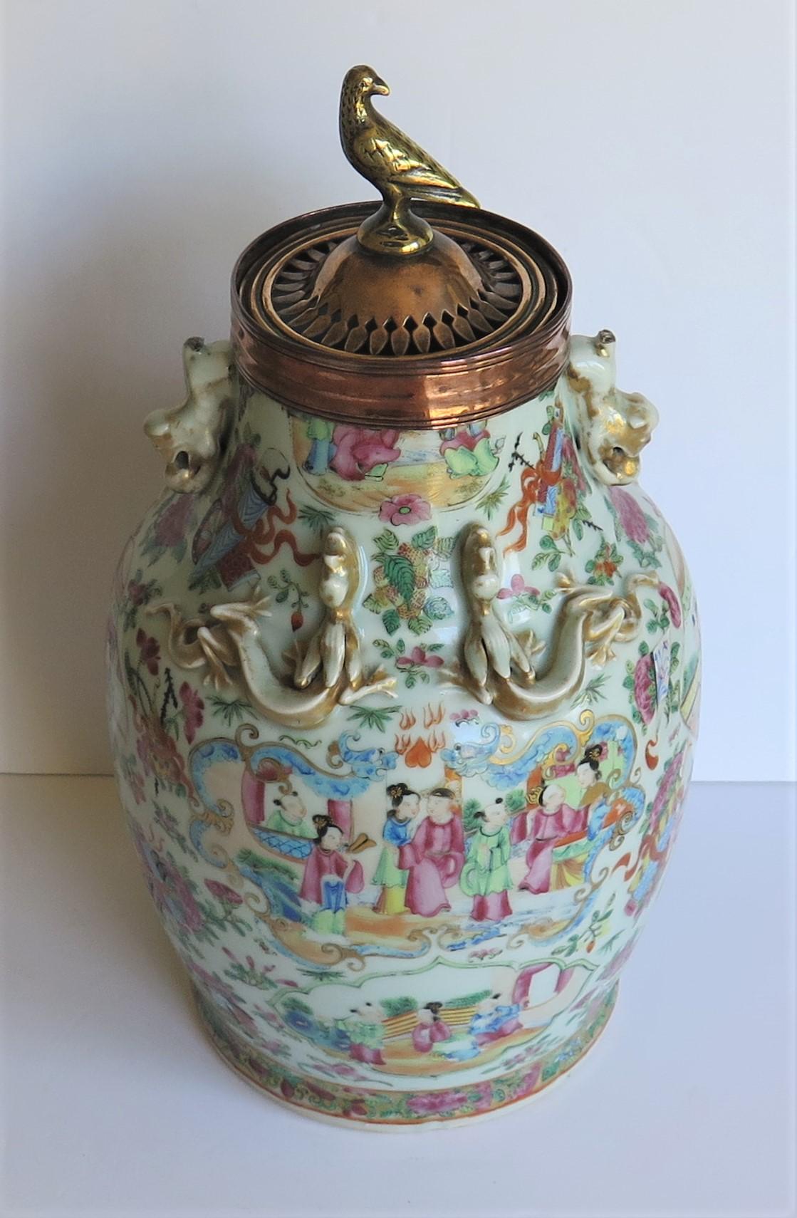 This is a very decorative Chinese export, (Canton) porcelain, hand painted, Rose Mandarin vase which has been reduced in height to make a Potpourri vase or urn having a copper and brass ring top with a bird, which we date to the early 19th century,