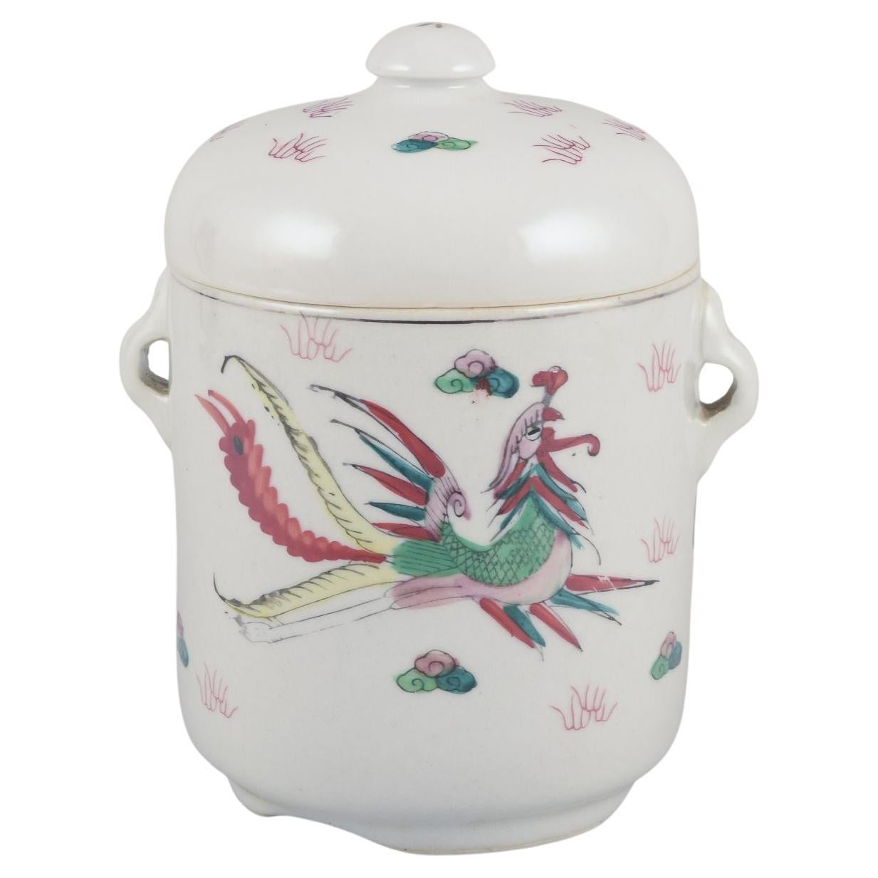 Chinese porcelain container with two lids. Hand-painted motif of dragons. 20th C
