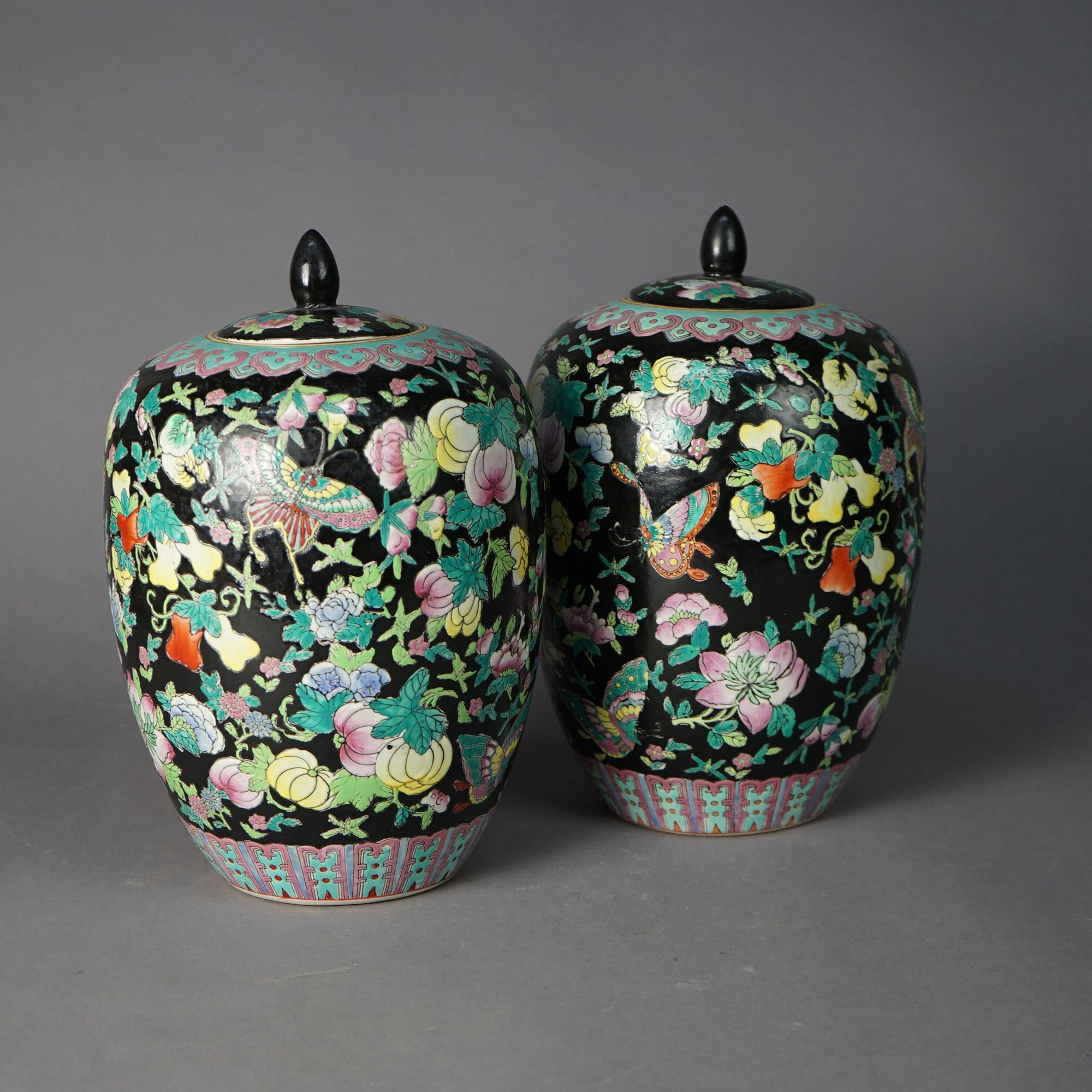 
A pair of Chinese covered ginger jars offer porcelain construction in urn form with garden design including flowers and butterflies, signed on base as photographed, 20th century

Measures - 13.75