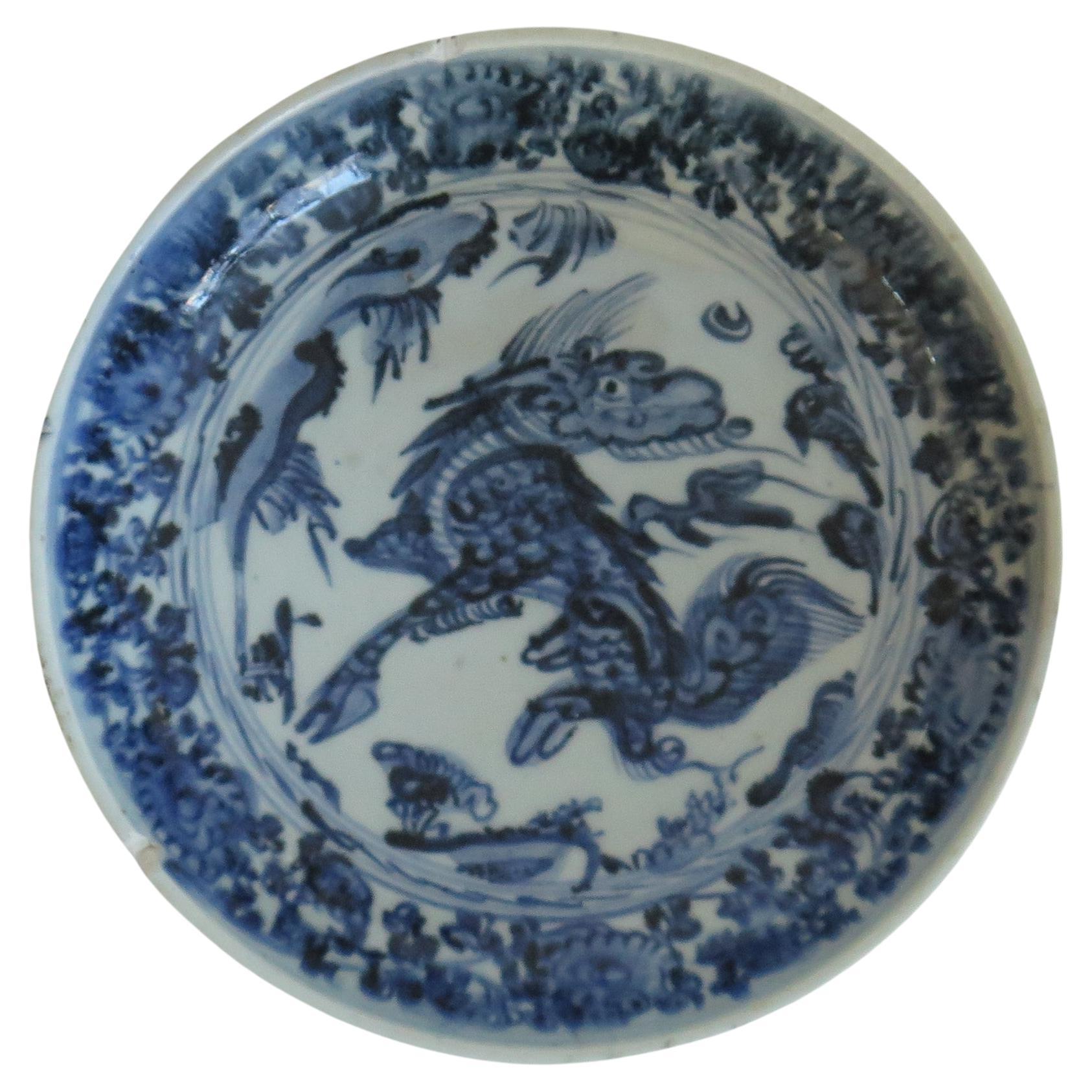 This is a Chinese Export porcelain Dish or Deep Plate hand painted in a typical Blue and white pattern, made during the reign of Wanli (1573 to 1620).

The dish is fairly heavily potted on a low foot and a well cut foot rim. The glaze is fairly