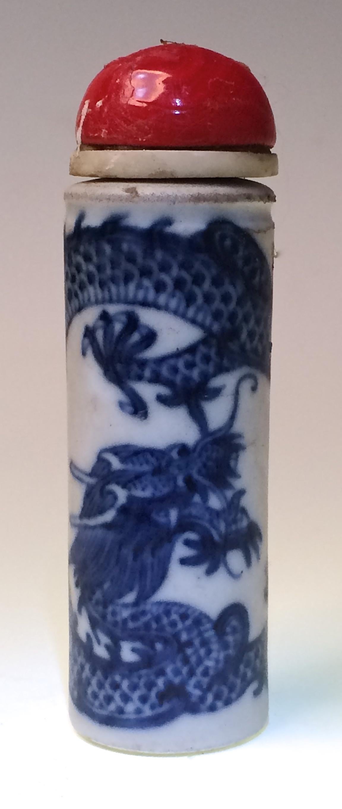 Chinese porcelain dragon snuff bottle, unusual cylindrical pillar form with no neck, unglazed top and bottom concentric grooved base, narrow aperture, painted in under glaze cobalt blue of a single five clawed dragon wrapped around the body chasing