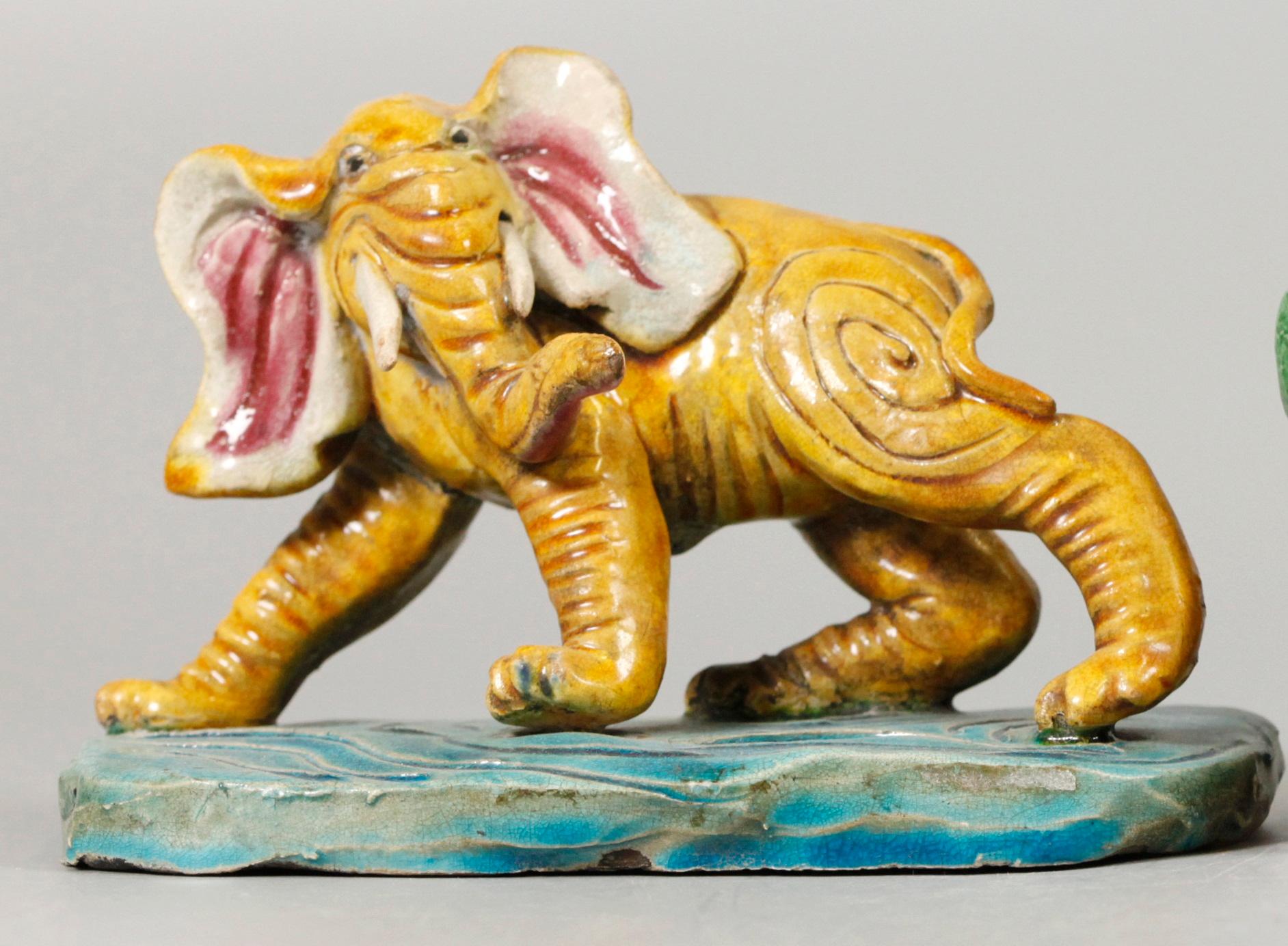 yellow glazed elephant on turquoise glazed porcelain base; measurements provided are the overall measurements of the item (including its porcelain base) 