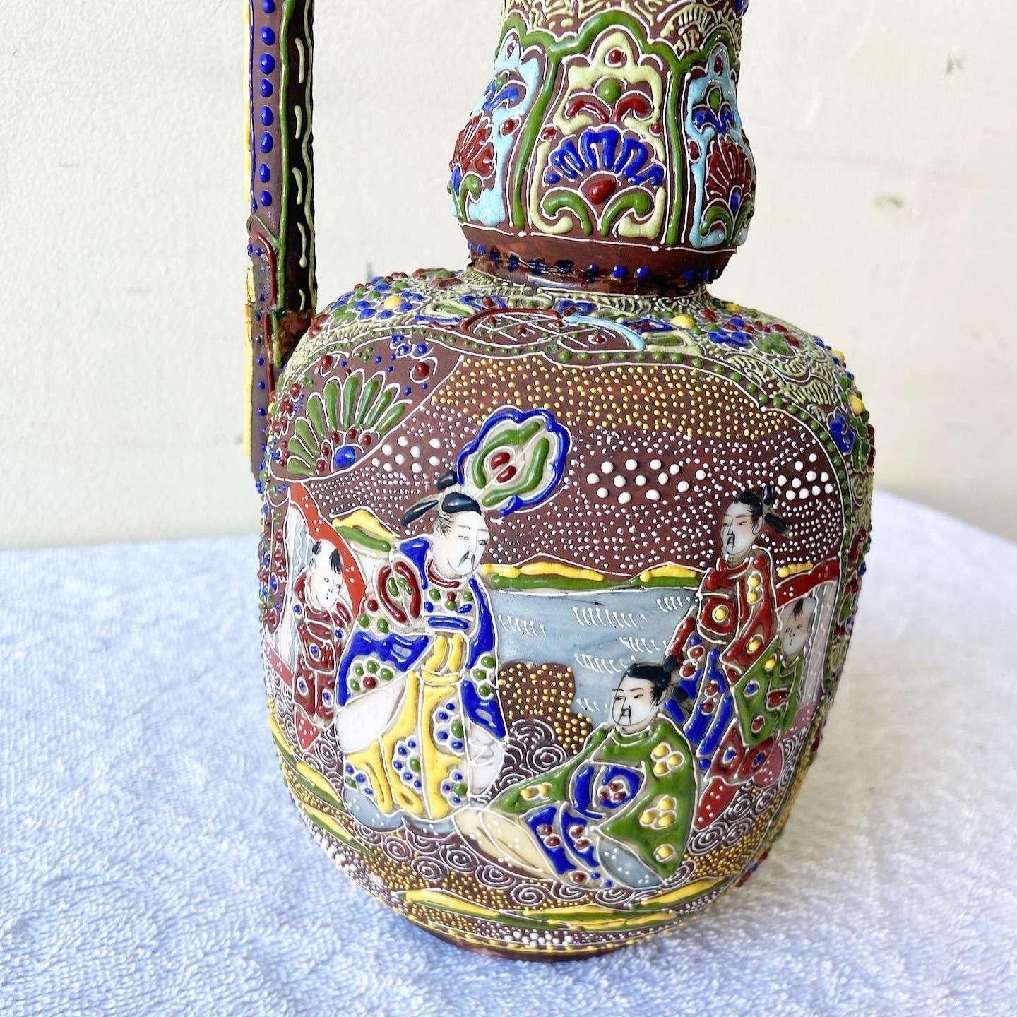 Amazing vintage Chinese pitcher. Features a hand painted and enameled design vibrant with green, red, yellow and blue, depicting a royal way of life.
