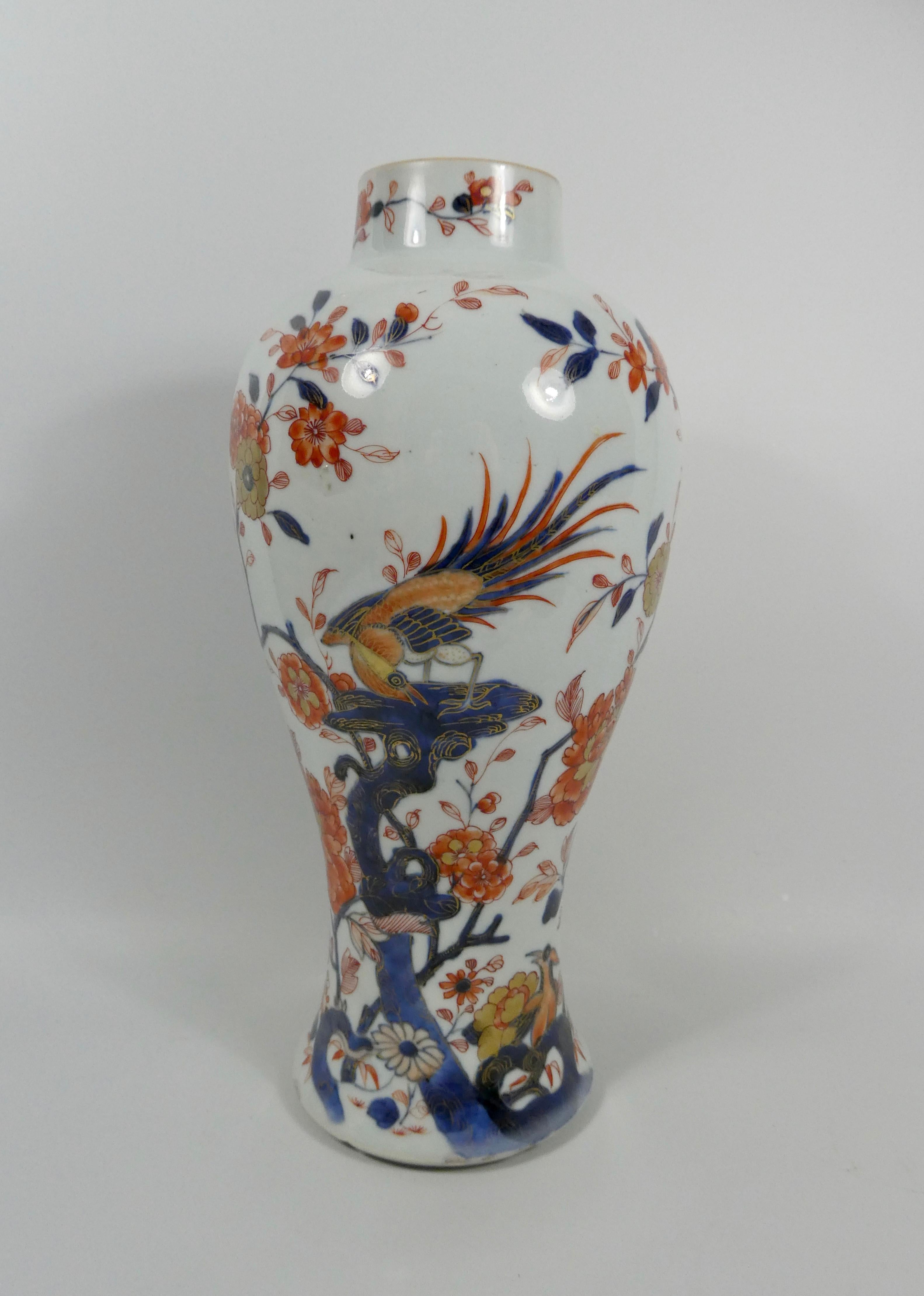 A rare garniture of large Chinese ‘Imari’ porcelain vases and covers, circa 1720, Kangxi period. Each elegant baluster shaped vase, well painted in the Imari style, with exotic birds, perched on rocks, amongst a profusion of flowering plants. The
