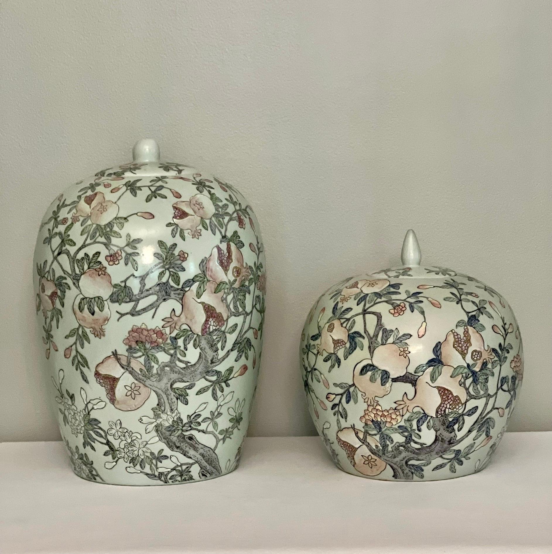 Pair of Chinese ovoid shaped ginger jars in a Celadon style glaze with floral and pomegranate motifs, late 19th to early 20th century. The muted, calming color scheme features soothing, pale hues of a fruitful pomegranate tree. The glaze has a