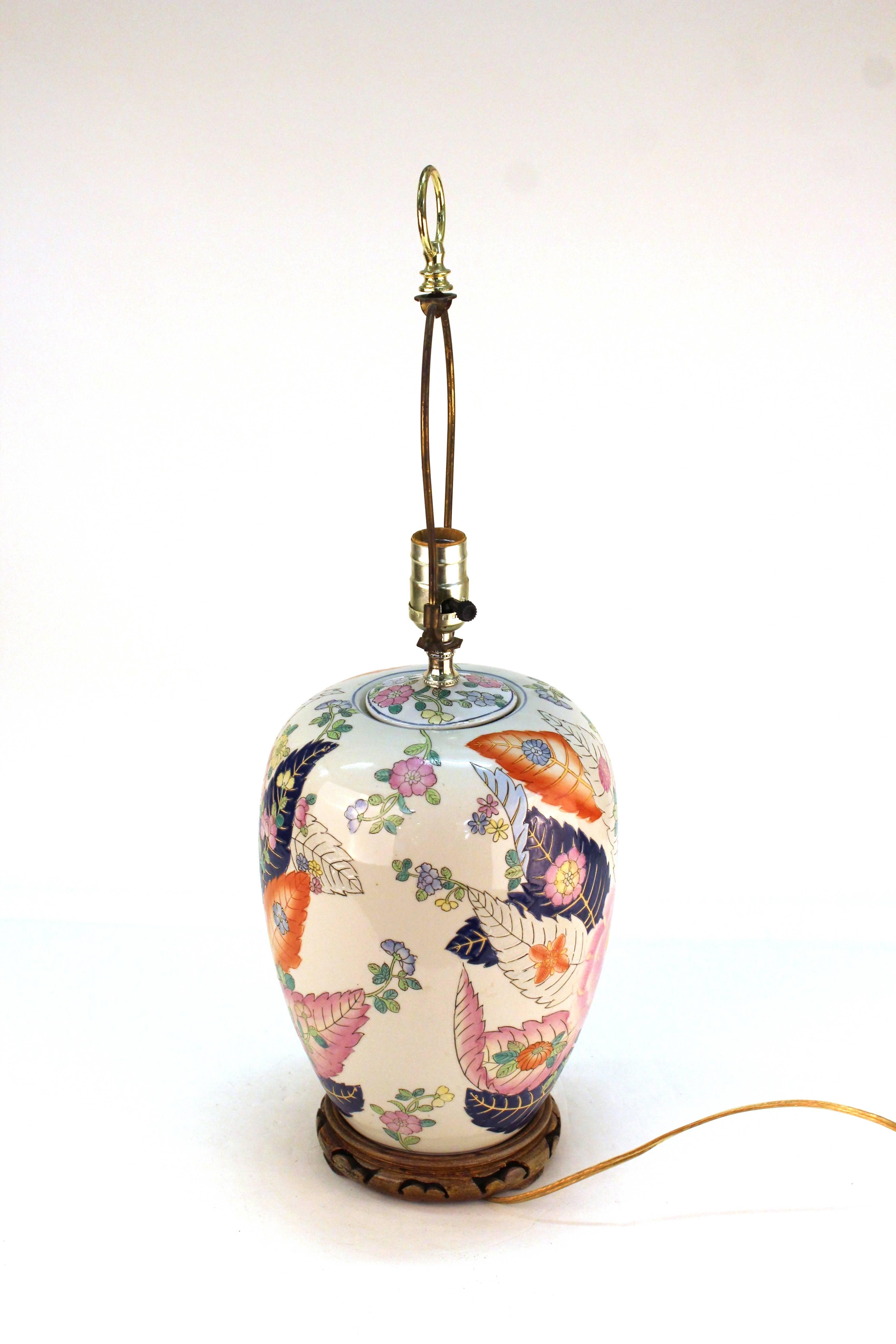 A Chinese porcelain jar table lamp with a motif of tobacco leaves in pink, orange and blue. The piece is in good vintage condition.