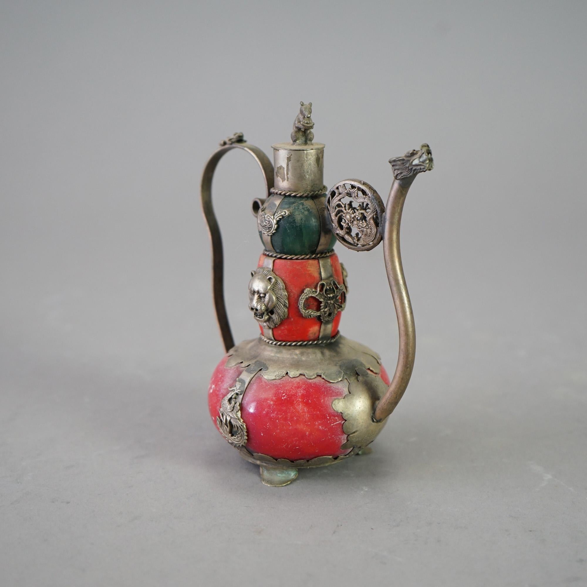 A miniature Chinese teapot offers porcelain vessel in double gourd form with silver overlay with dragons, frogs, and lions, stamped as photographed, 20th century

Measures- 5.5''H x 3''W x 4.5''D