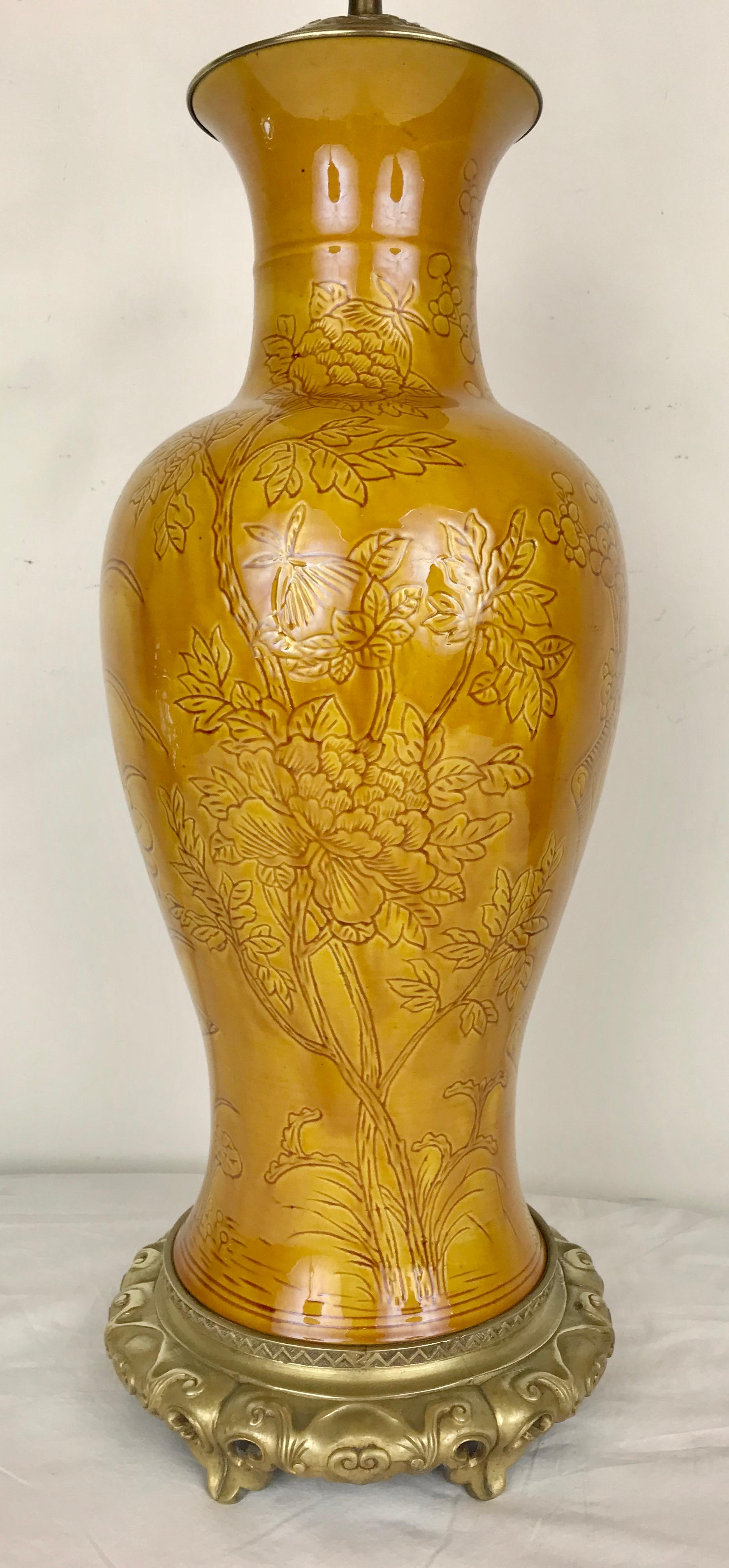 Diese beeindruckende Vase aus chinesischem Porzellan ist mit vergoldeten Metallbeschlägen versehen.
Das eingeschnittene Design zeigt Mohn-, Chrysanthemen- und Prunusblüten.