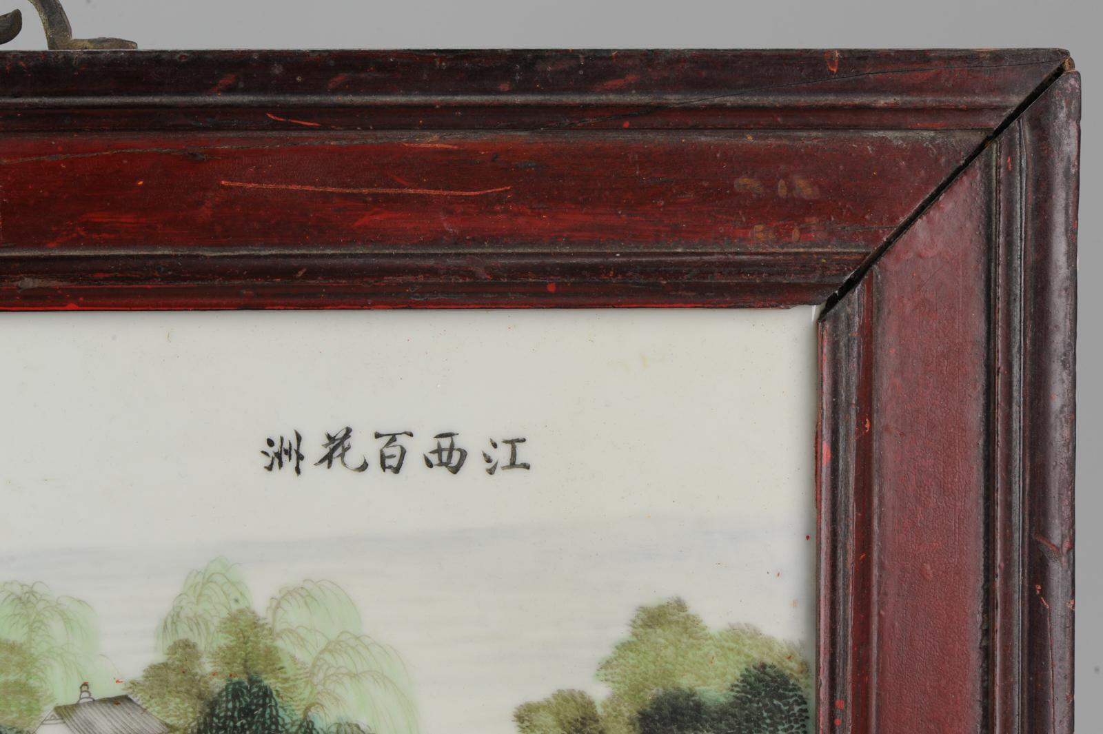 Faboulas Chinese porcelain Plaque with polychrome enamels in the family verte style, depicting a landscape view of Jingdezhen city In Jiangxi, could be Bai Hua Zhou or Xiao Gu Shan.

China, circa 1960.

In wooden frame.

Condition
Overall
