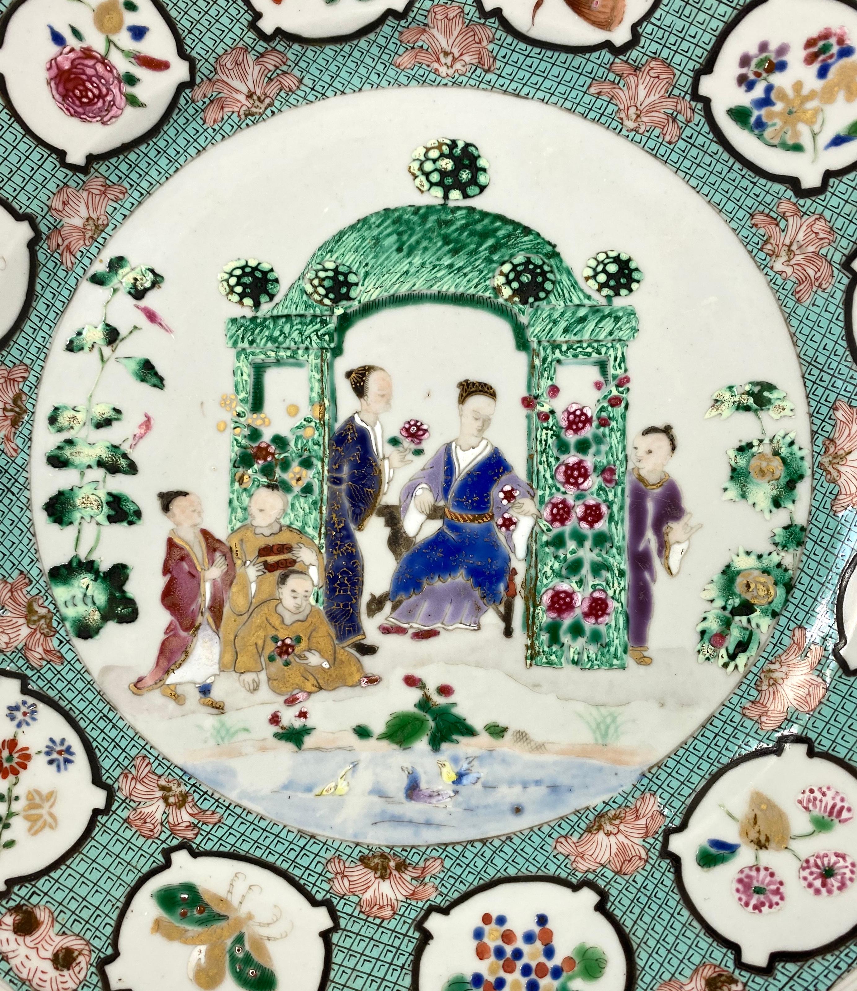 Chinese porcelain plate, circa 1738, Qianlong Period. Hand painted in fencai enamels, with the ‘Arbor’ pattern, after a design by Dutch artist Cornelis Pronk.
The central panel with figures within a topiary garden scene, watching ducks on a river.