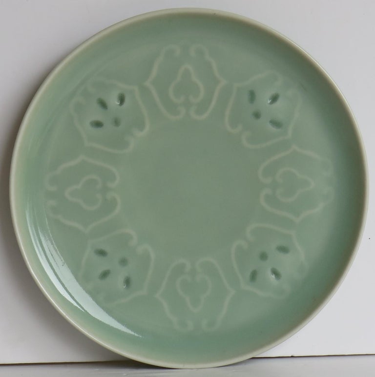 This is a very good Chinese porcelain plate or dish with moulded or incised decoration in the Ming style, which we date to the late Qing dynasty, circa 1900.

The plate has a diameter of 6 inches and is well potted on a low foot. 

The plate has