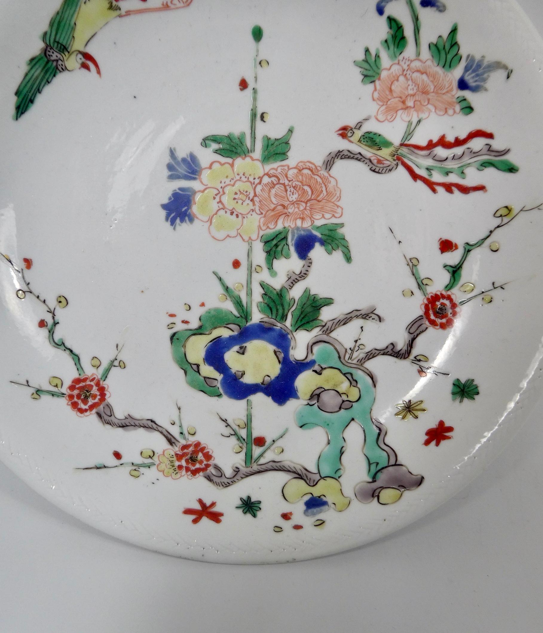 A rare Chinese porcelain dish, Shunzhi period, 1644-1661. Hand painted in wucai enamels, with a scene of exotic birds amongst flowering plants, emerging from rocks. Within an anhua moulded narrow border.
Measures: Diameter 22.5 cm, 8