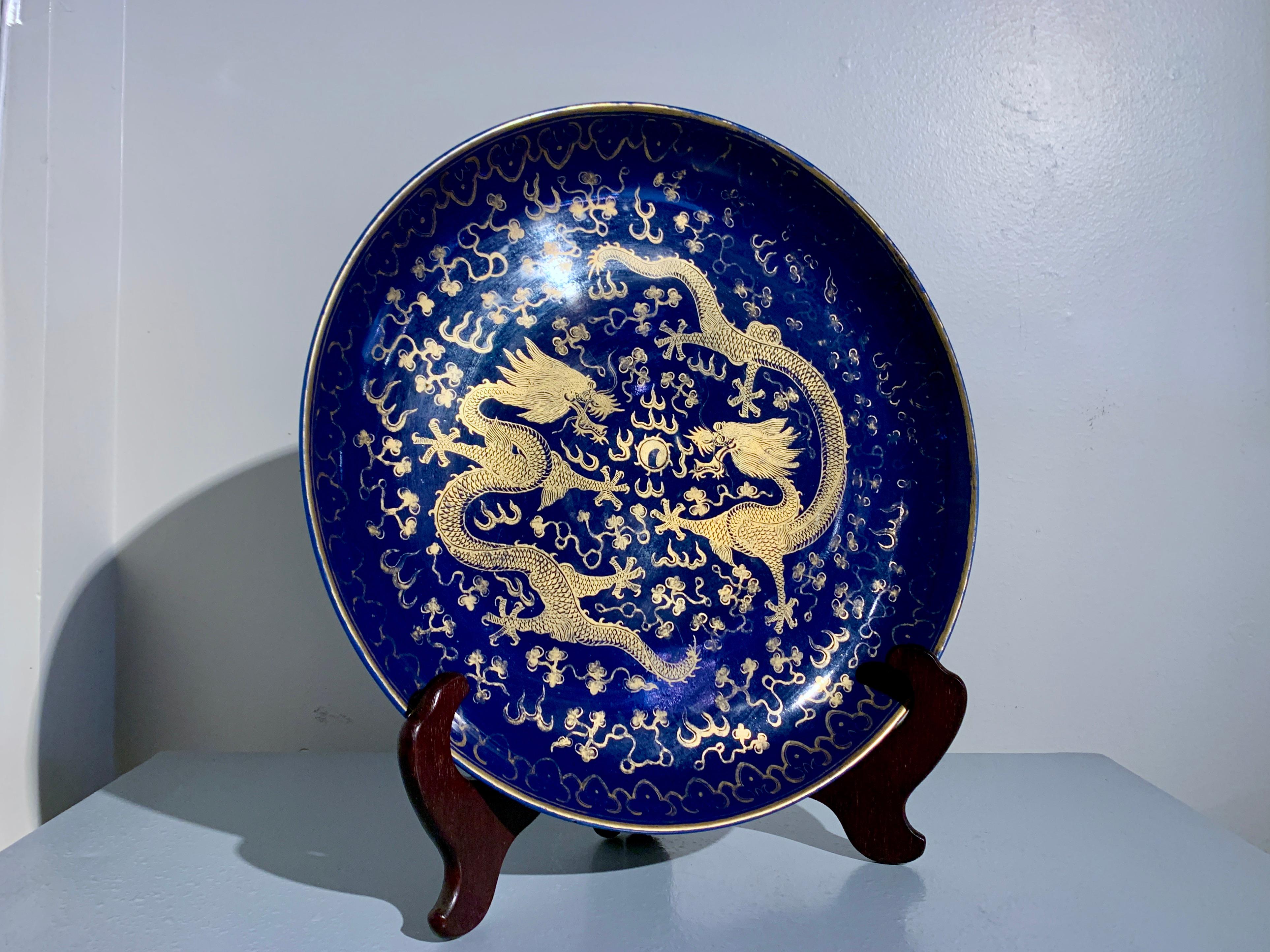A magnificent Chinese powder blue glazed porcelain charger with painted gilt decoration, late Qing Dynasty, circa 1900, China.

The large and impressive Chinese porcelain charger glazed a rich and deep cobalt blue, known as powder blue, and gilt
