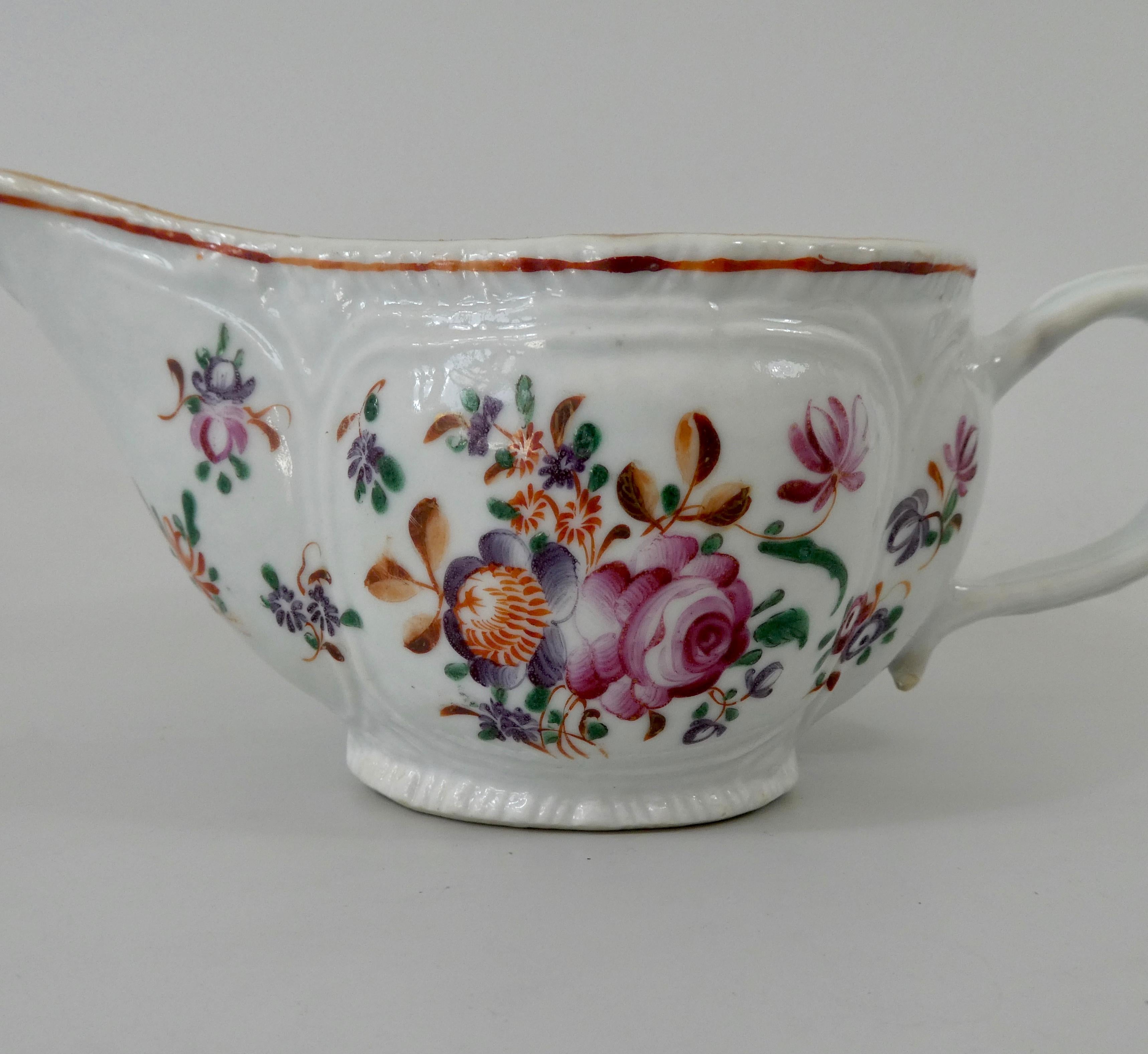 Chinese porcelain sauceboat, circa 1760, Qianlong Period. The silver shaped sauceboat, with moulded panels, containing sprays of flowers, painted in fencai, or famille rose enamels. Having a moulded loop handle.
Measures: Length 16.5 cm, 6