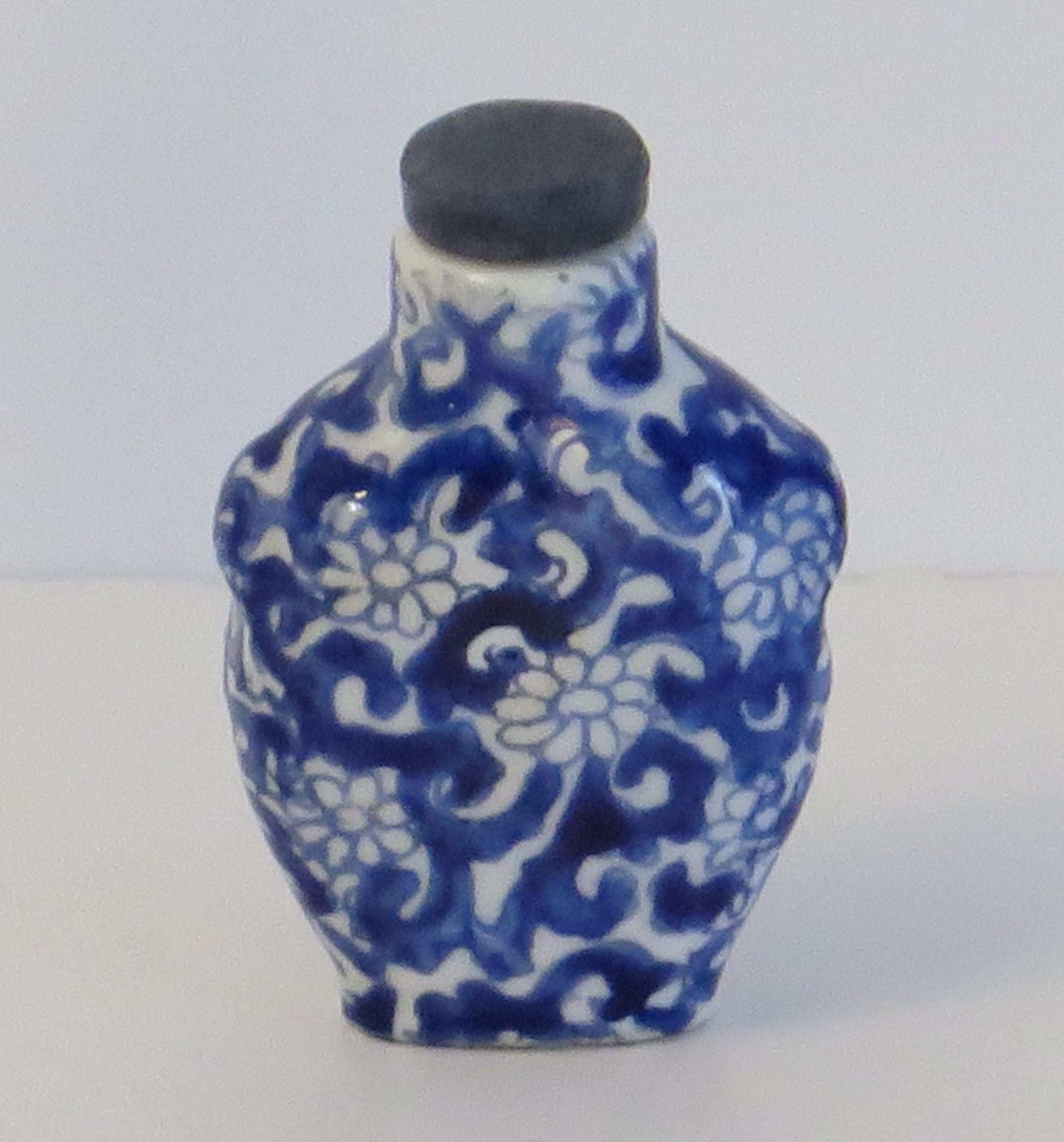This is a good Chinese Export snuff bottle, made from porcelain and hand painted in cobalt blue, dating to the mid 20th century, circa 1940.

This piece is well potted with a baluster shape, short neck and two moulded simulated handles to the