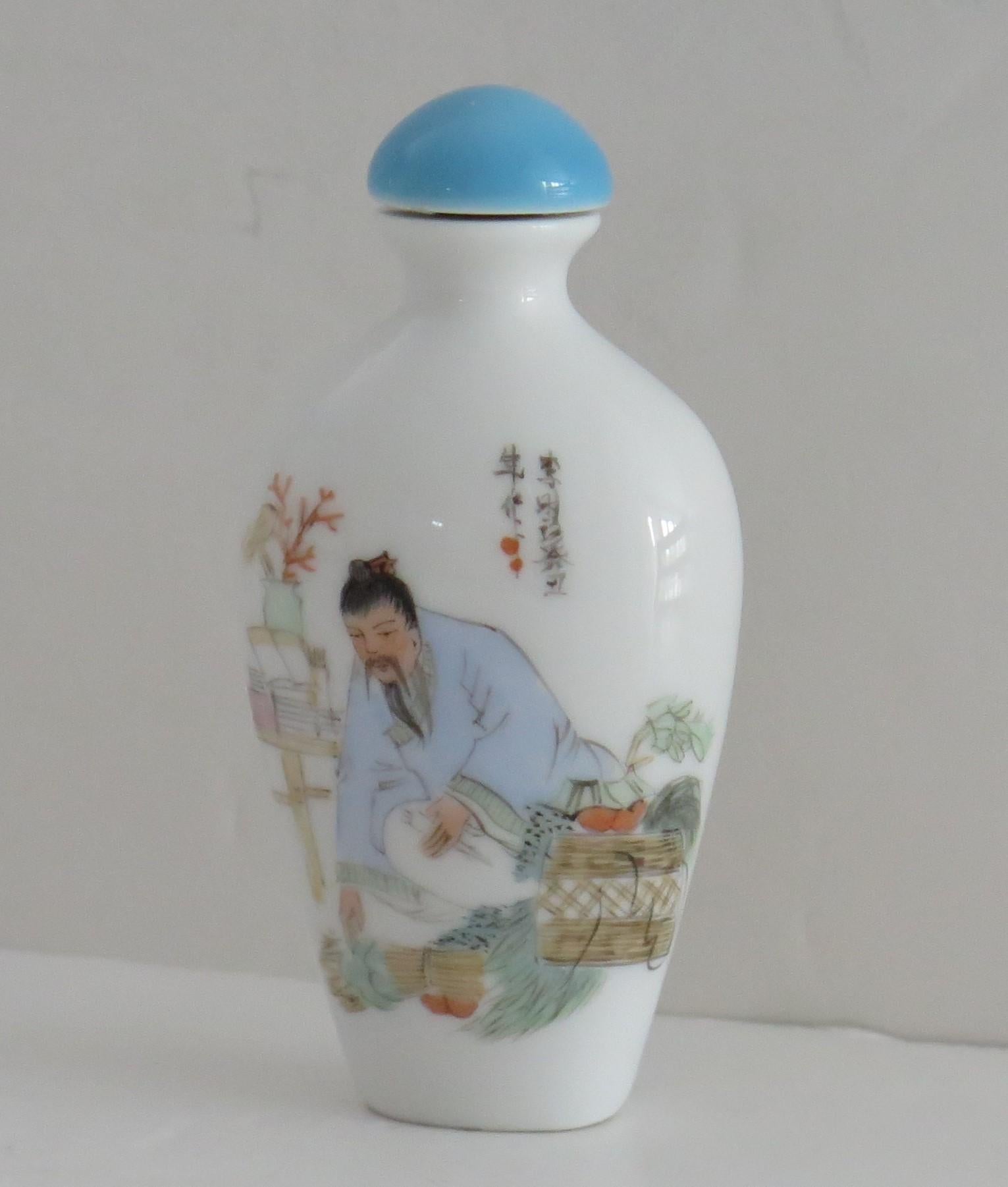 This is a very good quality Chinese snuff bottle, made from porcelain and finely hand painted in soft pastel shades, circa 1940.

This piece is well potted with an oval sectioned bottle baluster shape having a short neck.

The hand decoration is