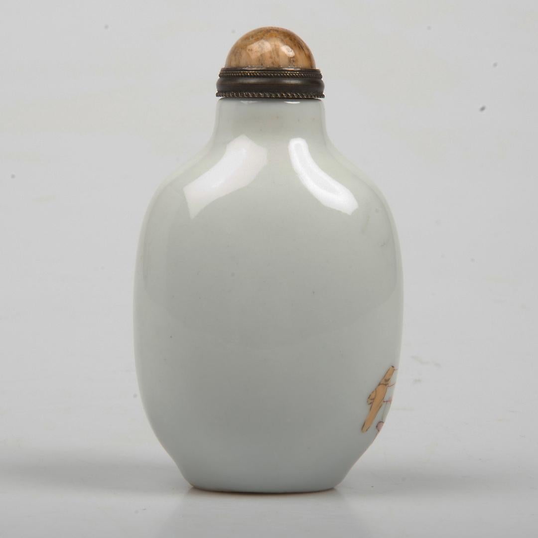 Very decorative, hand painted, Chinese snuff bottle, made from porcelain, circa 1940s.
The bottle has a narrow neck with a cone shaped stopper.
The main decoration is hand painted.