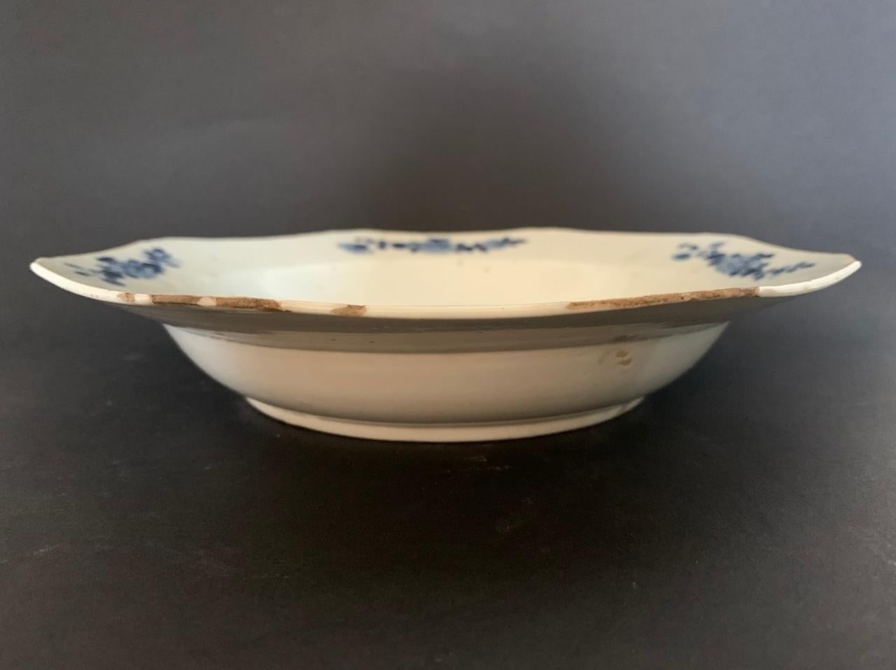 Nice plate of the Compagnie des Indes dating from the Qianlong period, XVIIIth century. Blue and white porcelain soup plate. On this plate are drawn in blue ink a set of plants or we can see magnolias or roses. 
This porcelain is characteristic of