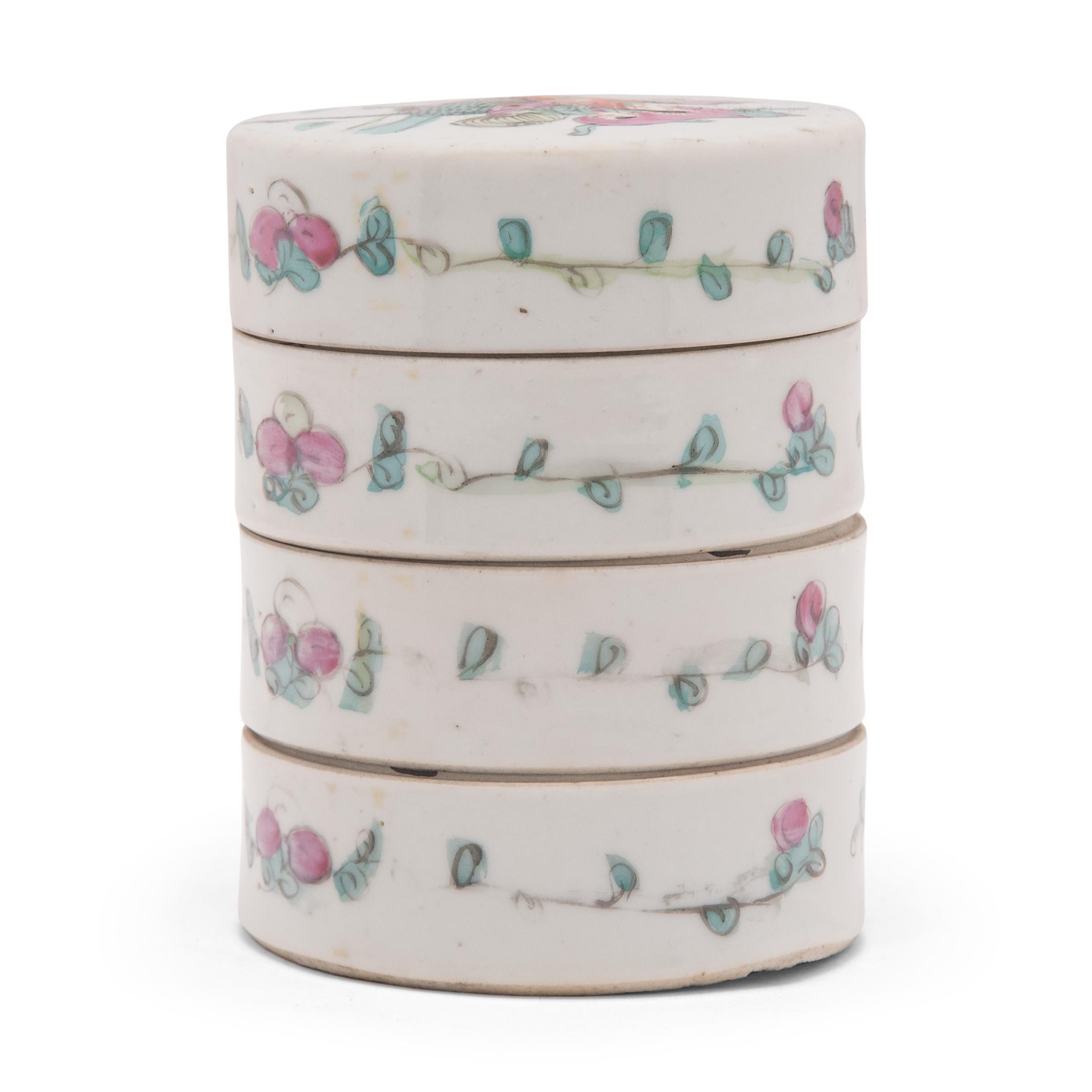 This early 20th-century porcelain stacking box would have been used in a woman's personal chambers to store jewelry, cosmetics, and precious small objects. The box has four tiers and is painted with overglaze enamels against white underglaze. The