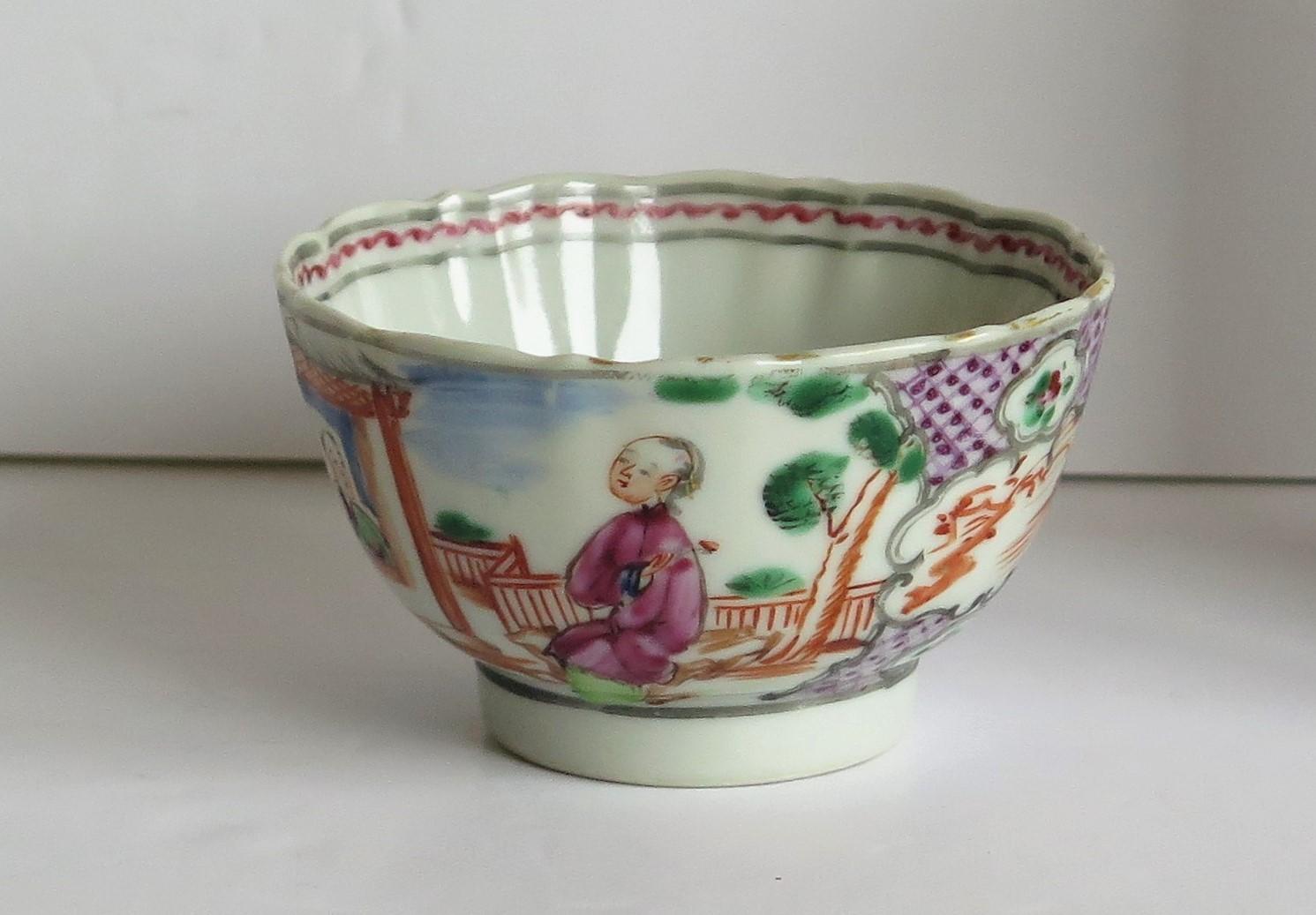 This is a finely hand painted Chinese porcelain tea bowl from the 18th century, Qing dynasty, Qianlong period, 1736-1795.

The bowl is beautifully decorated with two panels of figure scenes alternating with two magenta border panels. The figural