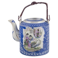 Vintage Chinese porcelain teapot with a motif of women in a landscape. Ca. 1930