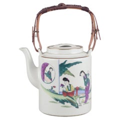 Vintage Chinese porcelain teapot with a motif of women in a landscape. Ca. 1930