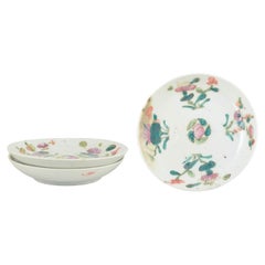 Chinese porcelain. Three small plates with famille rose decoration. 19th C.