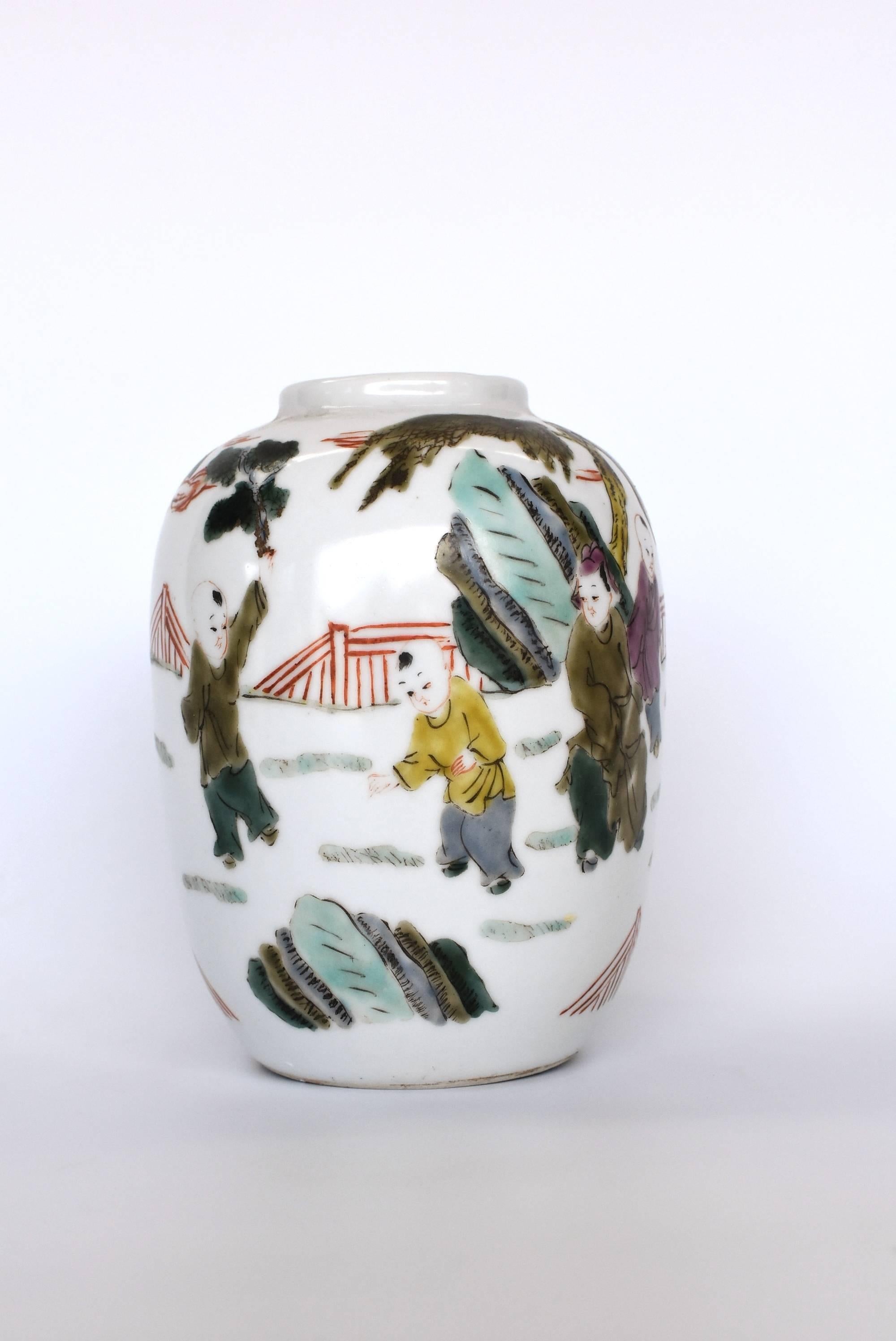 A highly collectible, hand painted Porcelain vase from the Chinese Republic Era. Typically featuring playful children and demure women, porcelain pieces from that period were painted with pastel colors on mainly white background. The use of muted