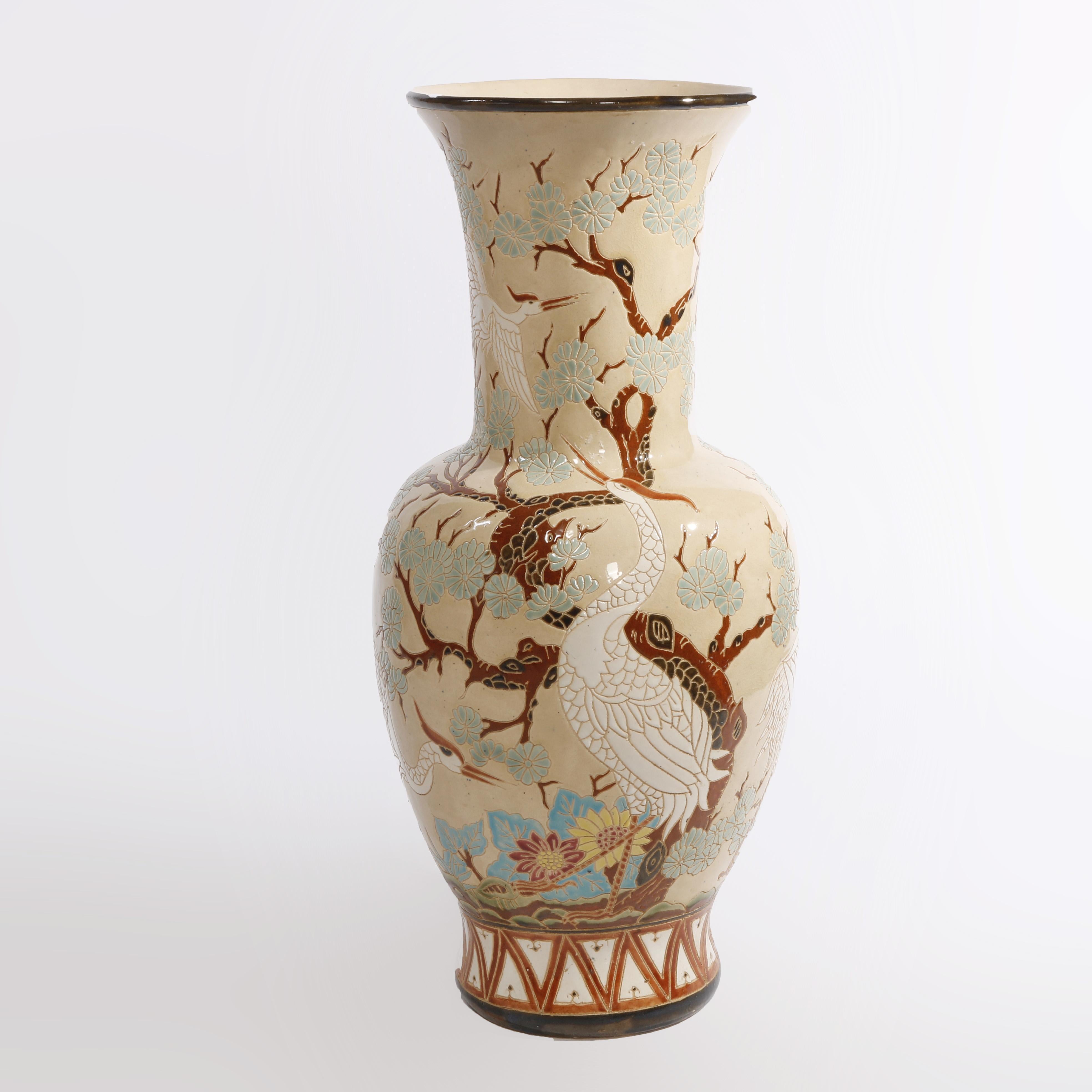 A Chinese floor vase offers pottery construction with allover marsh scene having cherry blossoms and cranes, 20th century

Measures - 32.5''h x 14.5''w x 14.5''d