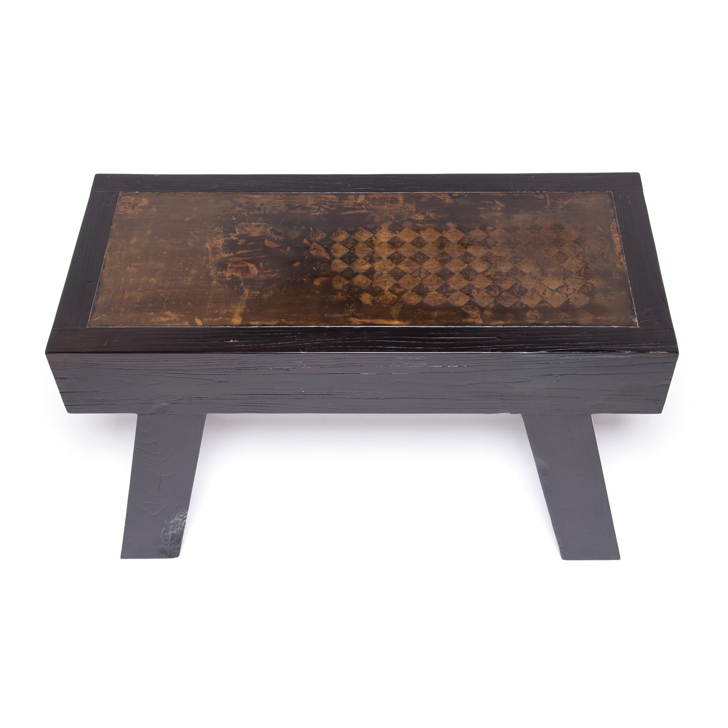Topped with a 19th-century decorative architectural tile, this statement table brings together modern functionality with ancient tradition. The incised earthenware top resembles a weiqi game board, the ancient strategy game traditionally practiced