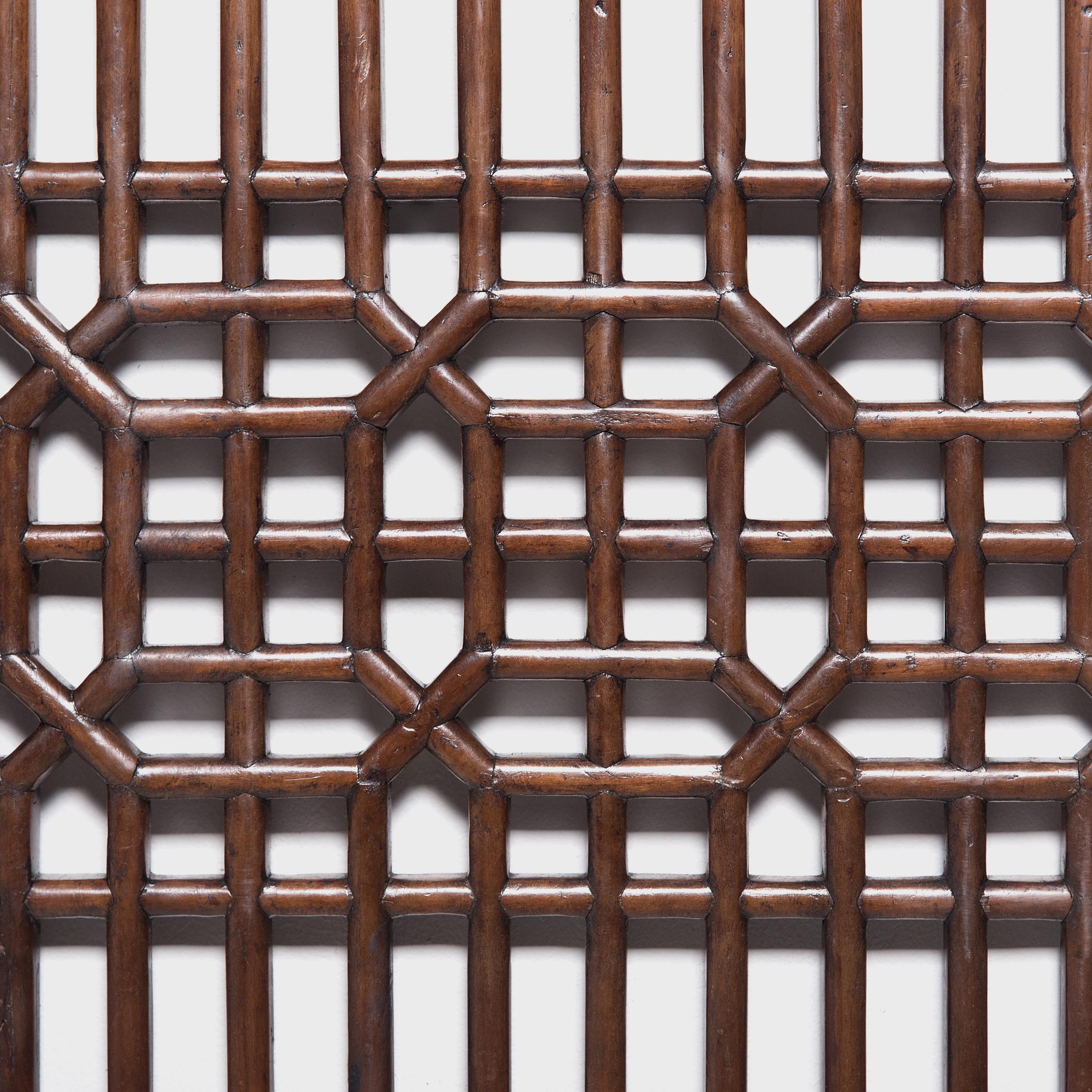 Dated to the early 19th century, this lattice panel was originally a window insert to a set of tall paneled courtyard doors. The geometric lattice pattern is linear and open, and was designed to allow light and fresh air to flow into a room while