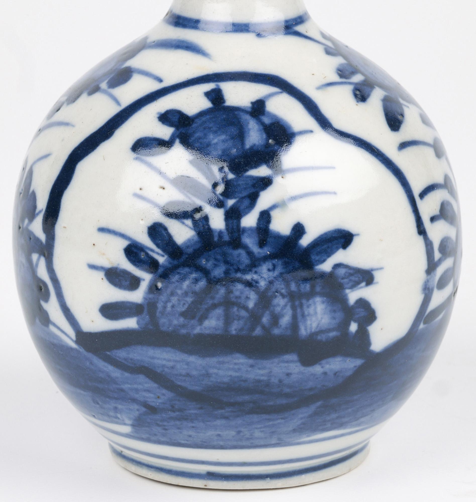 A stylish antique Chinese Provincial Ming pattern porcelain onion shape bottle vase dating from the late Ming or early Qing period. The vase stands on a narrow round unglazed foot rim with a recessed base and has a round bulbous shaped body with