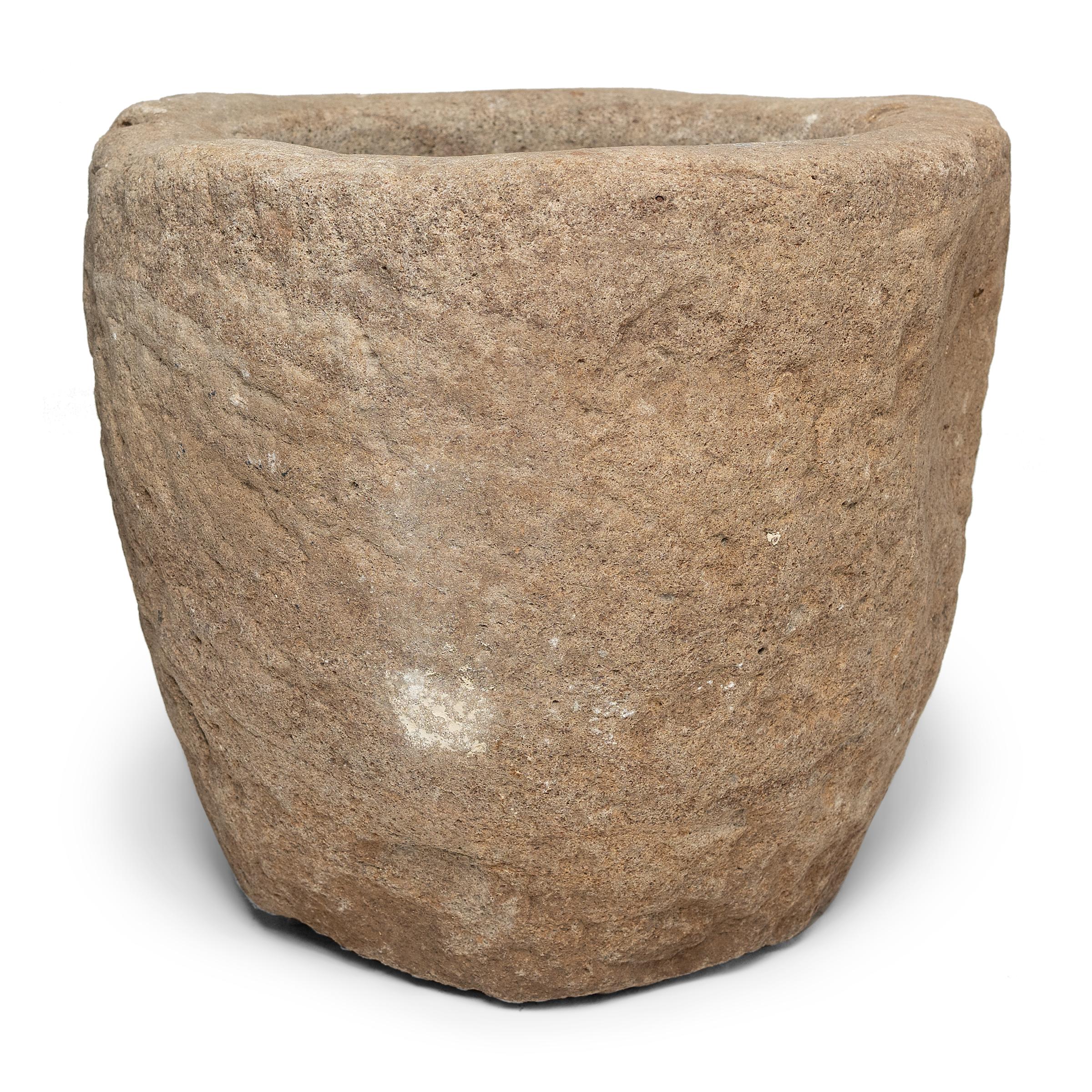 Hand carved from a single block of limestone, this early 20th century stone vessel was originally used as a mortar to grind rice and other raw materials. The large mortar has Minimalist appeal, its simple form showcasing the natural color and