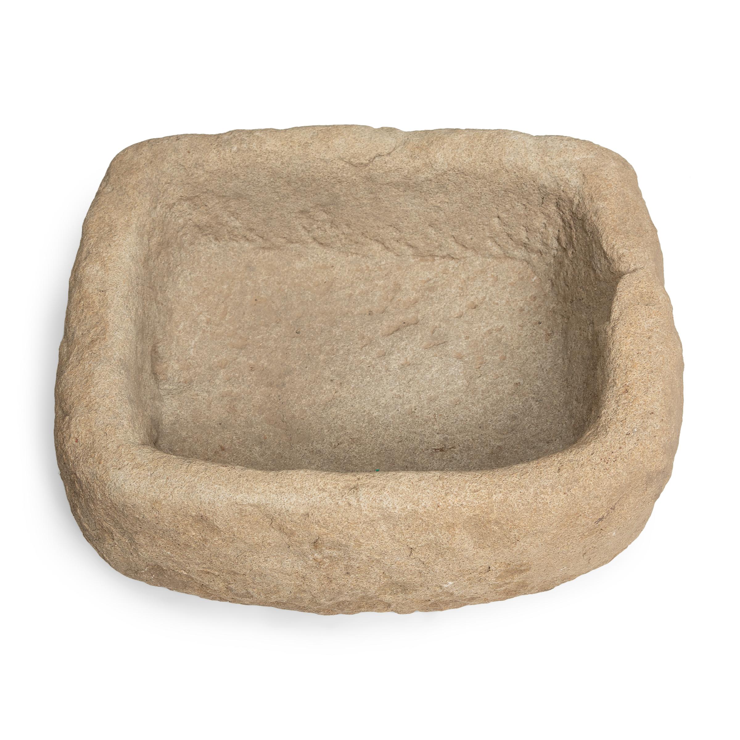 Once used on a provincial Chinese farm to hold water or animal feed, this early 20th-century stone trough is celebrated today for its organic form and rustic authenticity. Hand-carved from solid limestone, this rectangular trough has an asymmetrical