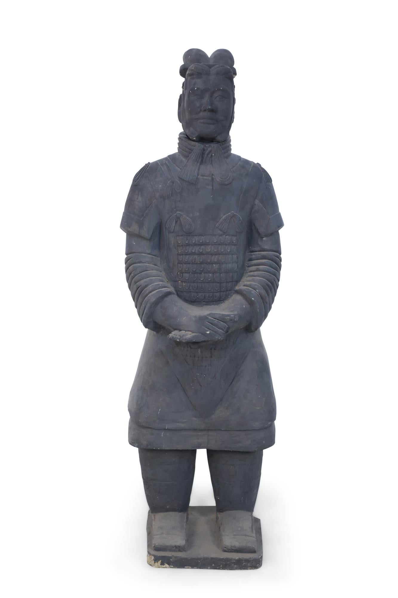 Chinese Qin Dynasty-style (20th Century) life-size terracotta soldier statue standing with hands clasped on a rectangular base. (Head is removable).