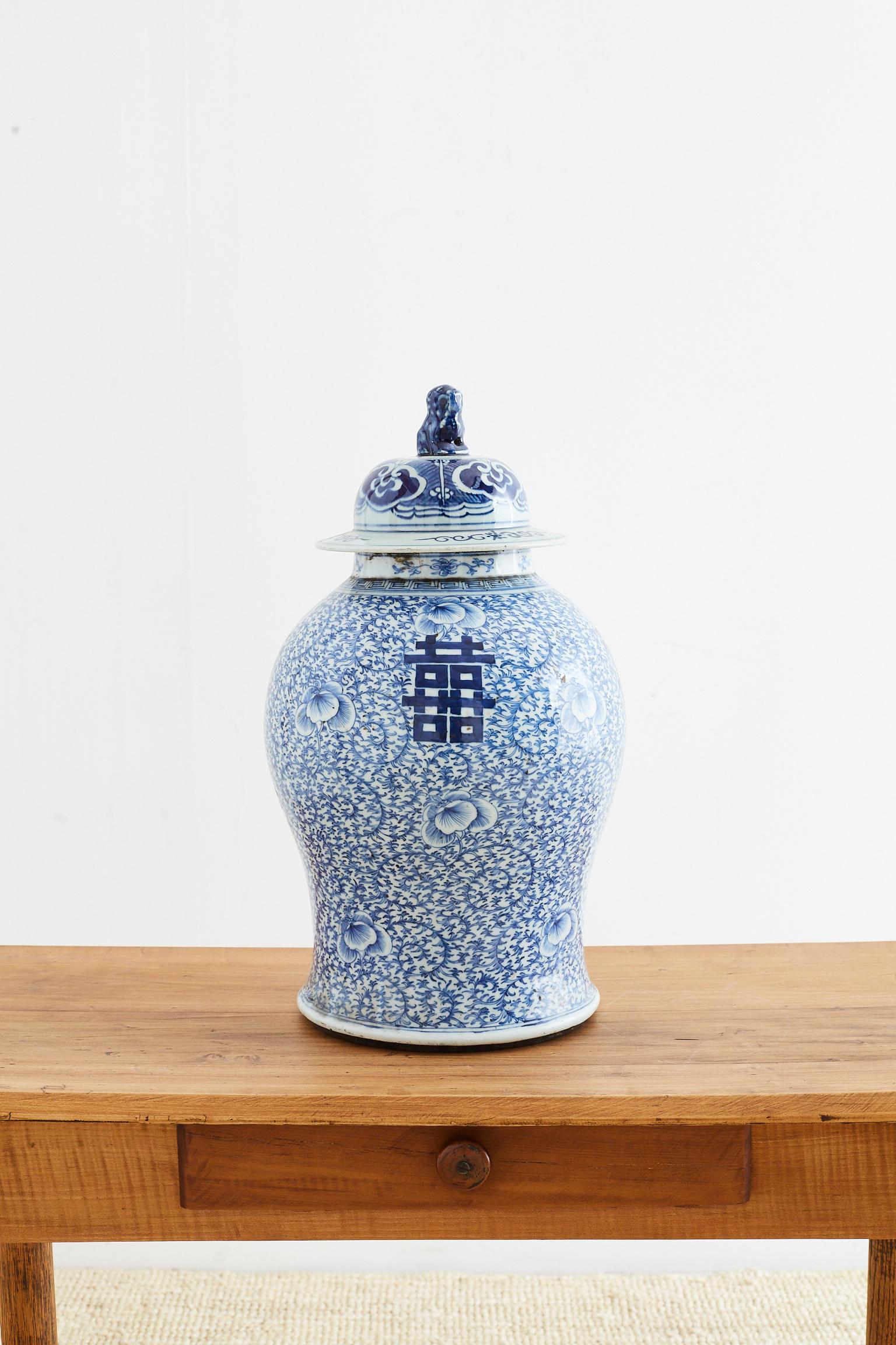 Impressive Chinese late Qing dynasty period blue and white porcelain ginger jar or temple vase. Features a scrolling vine pattern background and double happiness design. Very heavy with a Chengua Ming period mark on bottom, but probably later
