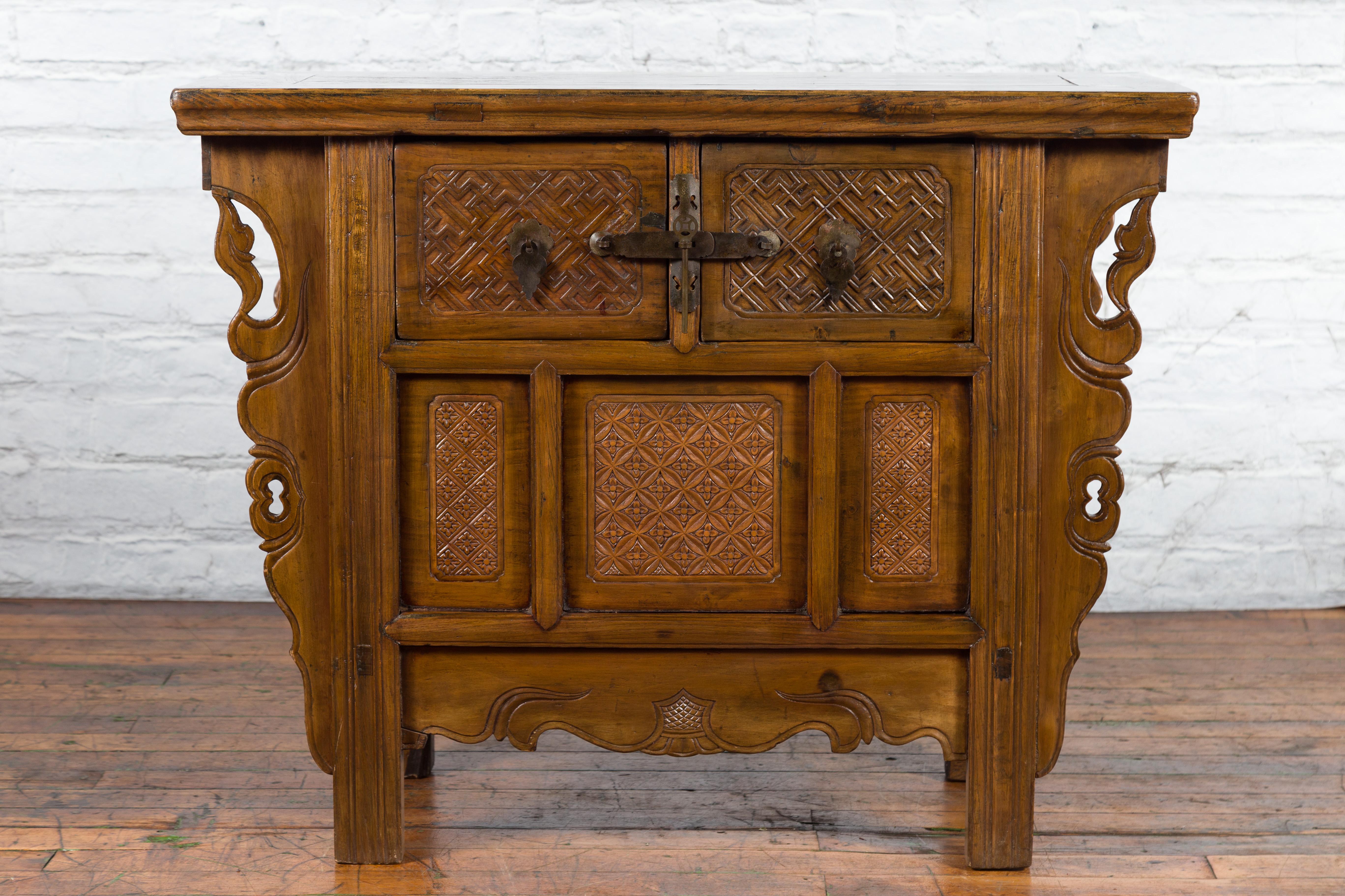 A Chinese Qing Dynasty period carved altar coffer from the 19th century, with two drawers and geometric motifs. Created in China during the Qing Dynasty, this altar coffer features a rectangular top with central board, sitting above two dovetailed