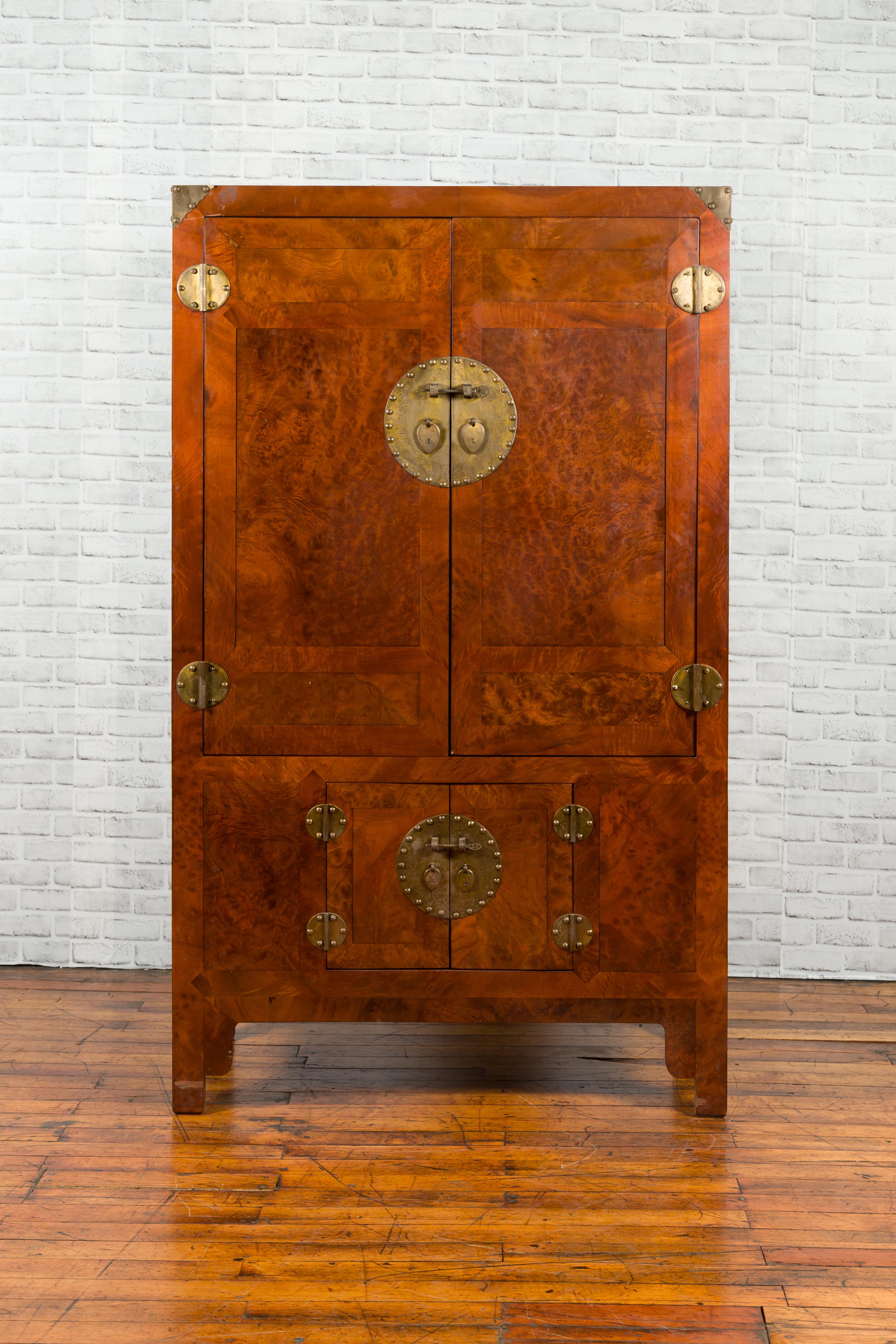 A Chinese Qing Dynasty period burl and elm wood cabinet from the early 20th century, with brass medallion hardware. Created in China during the late Qing Dynasty period in the early years of the 20th century, this cabinet attracts our attention with