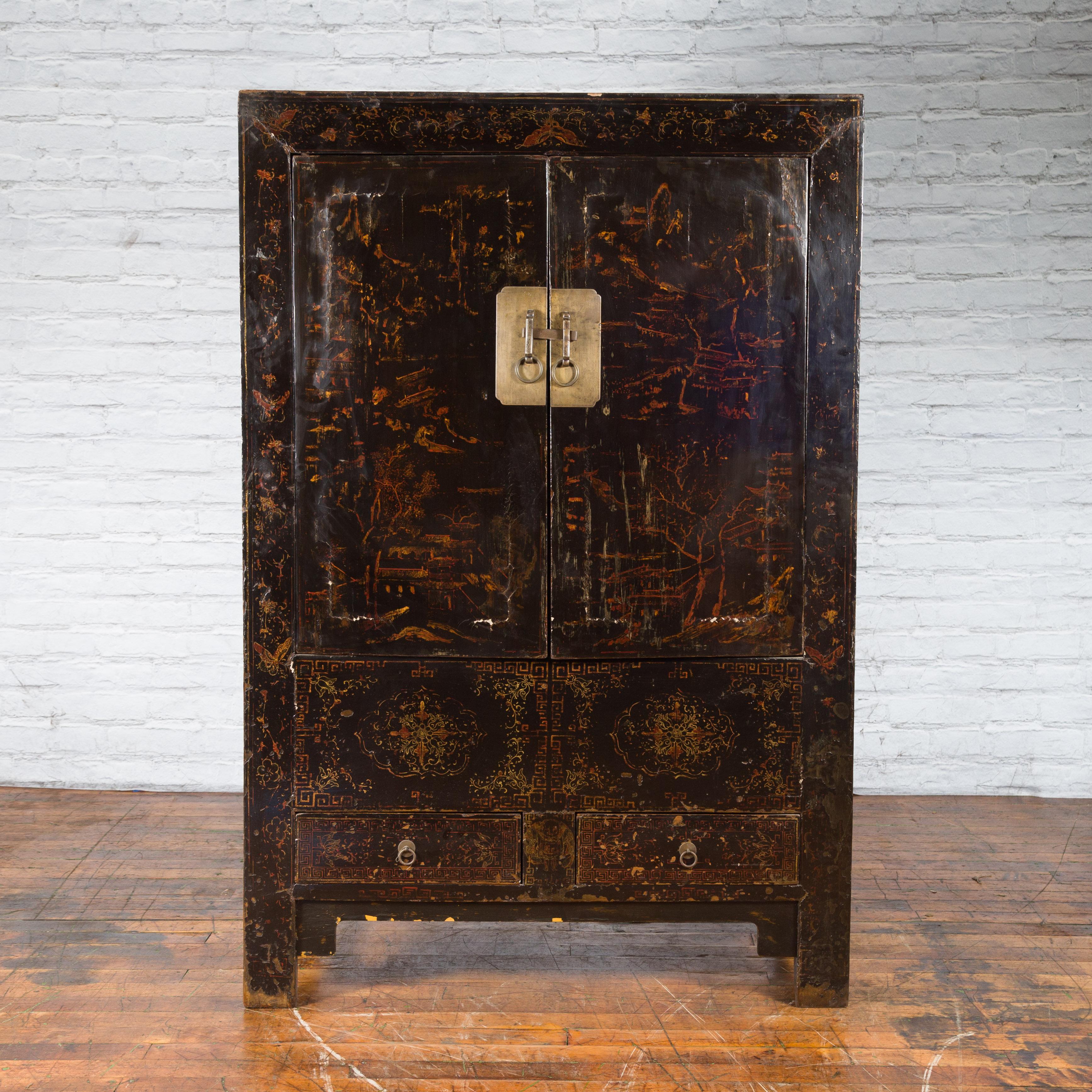 A Chinese Qing Dynasty period cabinet from the 19th century, with original black lacquer and faint hand-painted décor. Created in China during the Qing Dynasty period in the 19th century, this wooden cabinet features a linear silhouette perfectly
