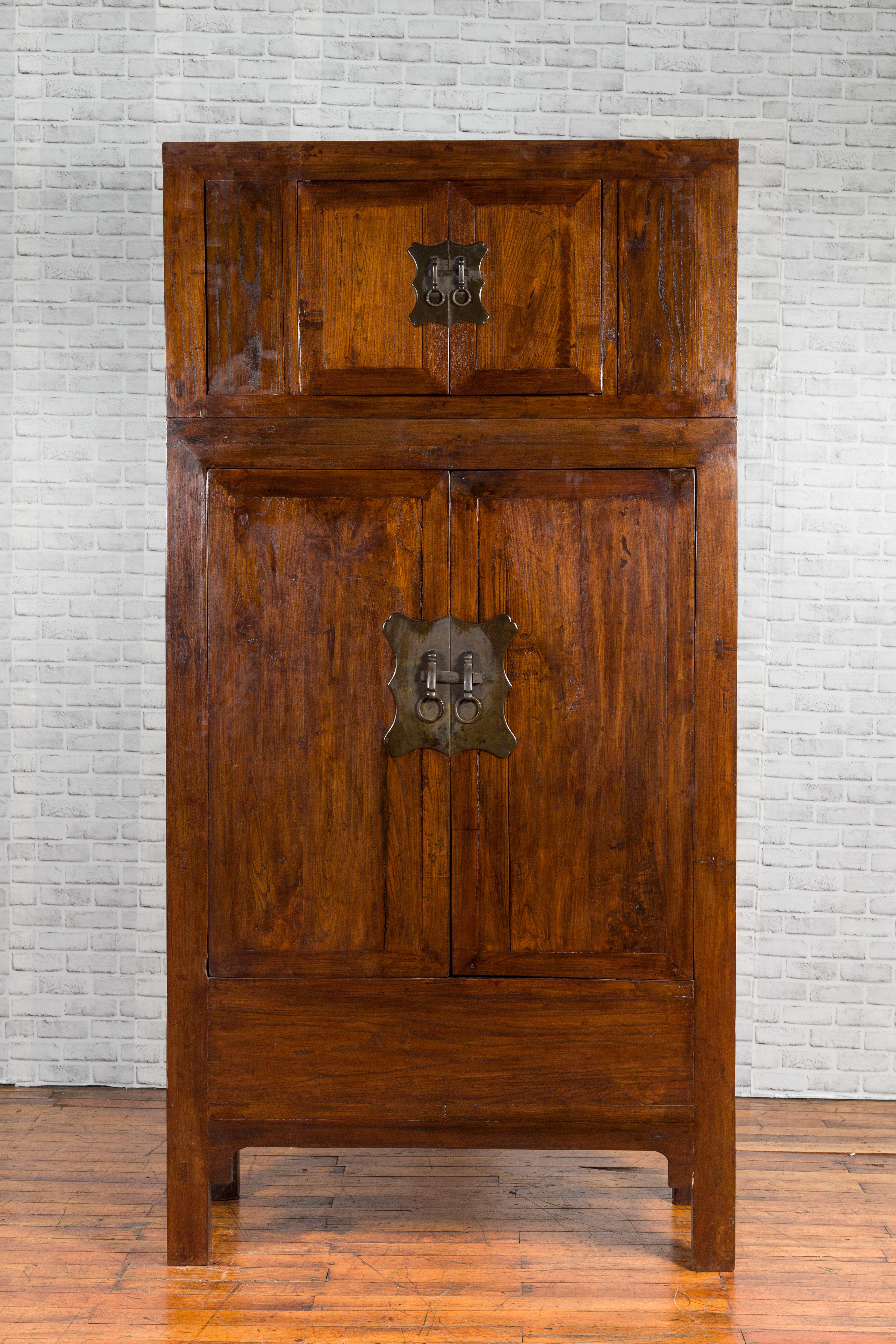 A Chinese Qing Dynasty period compound cabinet from the early 20th century, with doors, drawers and removable panel. Created in China during the early years of the 20th century, this compound cabinet features a smaller storage chest stacked on top