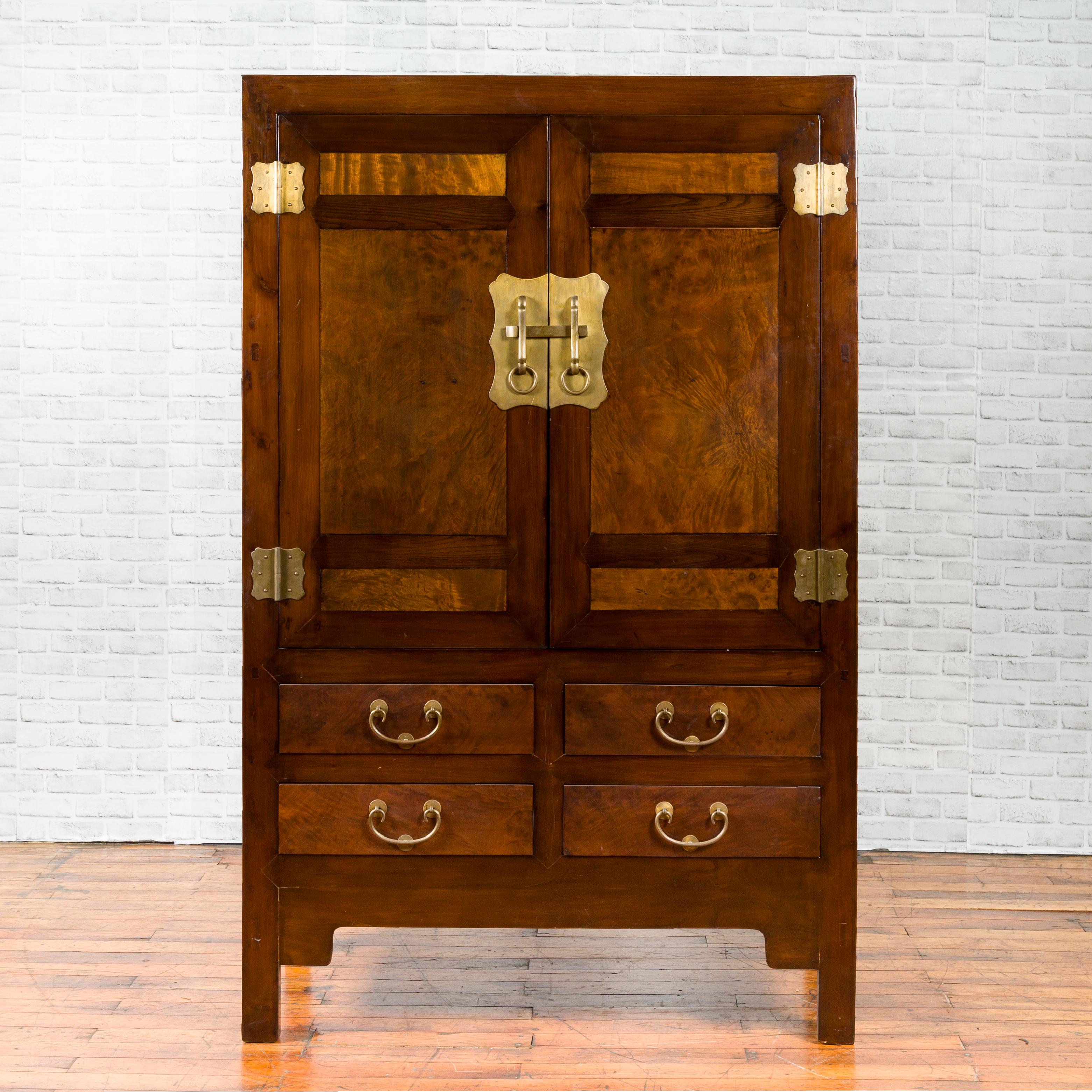 A Northern Chinese elm and burl wood cabinet from the early 20th century, with newer brass hardware, two doors and drawers. Created in Hebei during the first quarter of the 20th century, this two-toned cabinet features two doors with burl accents