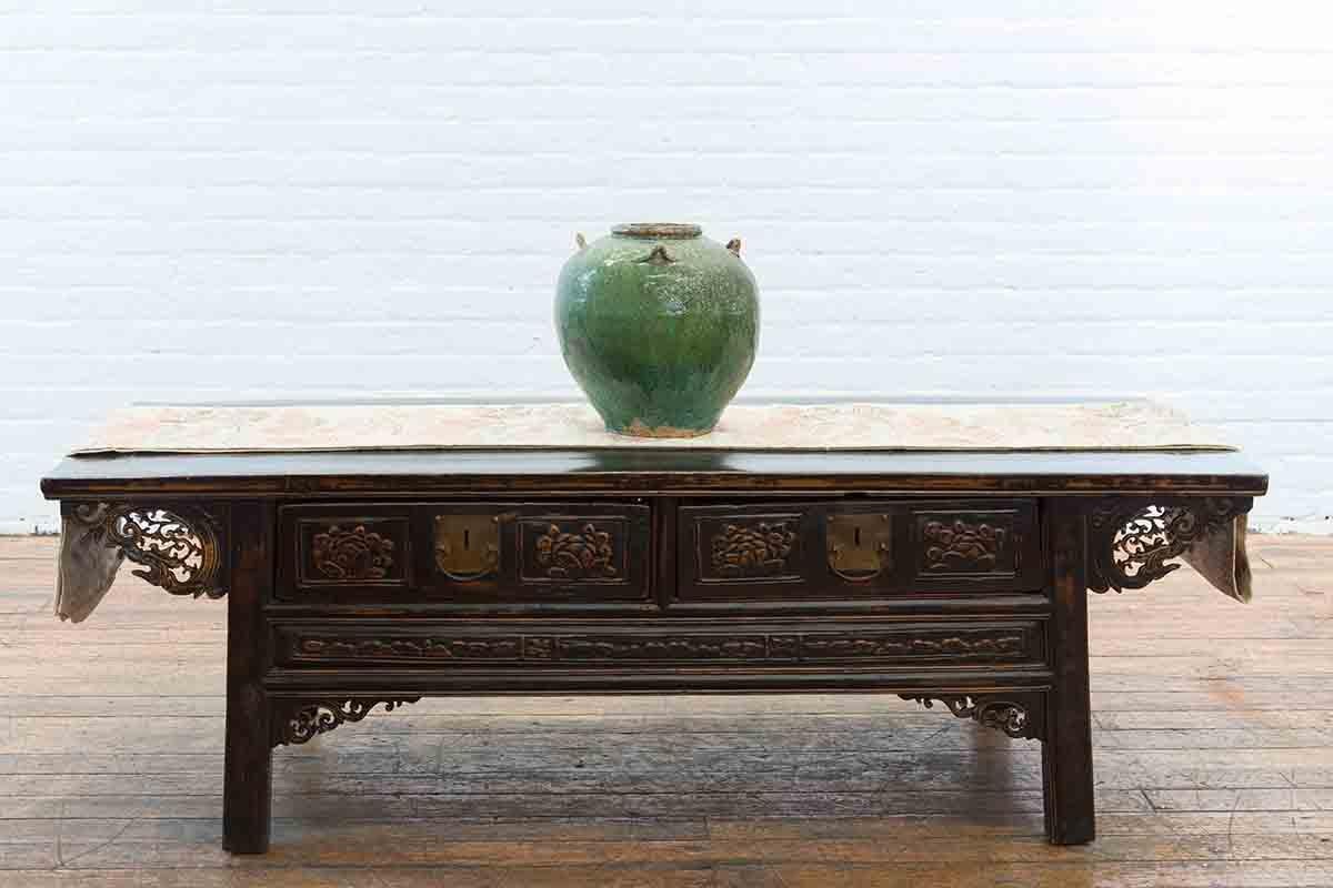 A Chinese Qing Dynasty antique green glazed water vessel from the 19th century, with petite loop handles. Created in China during the 19th century, this water vessel features a generous circular tapering body adorned with a green glaze and brown