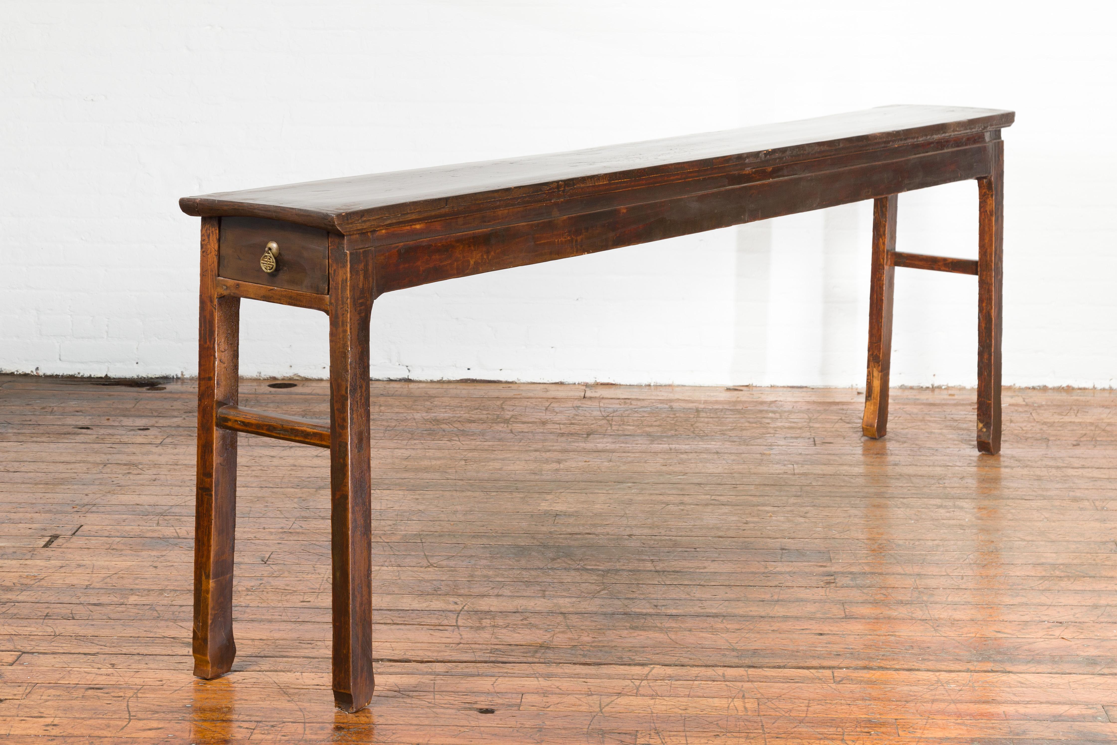 A Chinese Qing dynasty period long altar console table from the 19th century, with original patina. Featuring a long, simple design, this Qing dynasty altar table features a rectangular top sitting above an apron showcasing two drawers at the ends.
